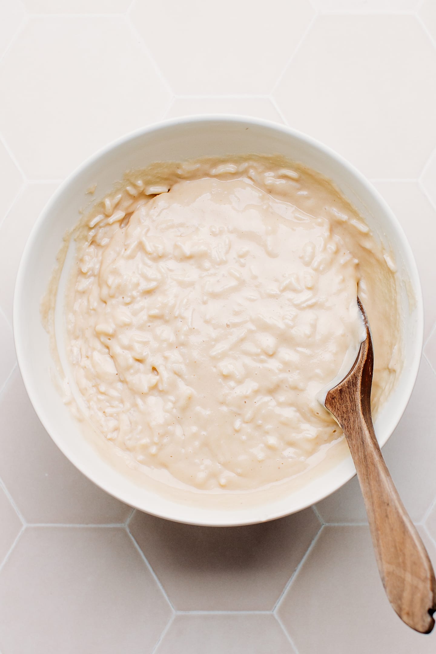 Rice coated with cheese sauce in a bowl.