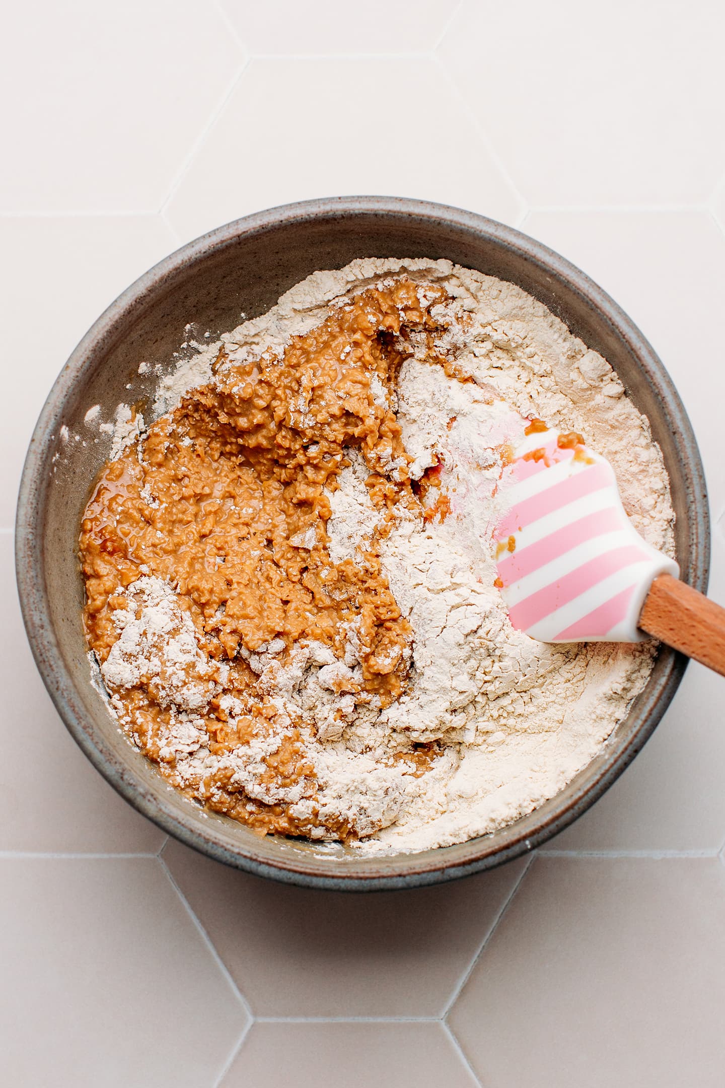 Mixing processed TVP with vital wheat gluten in a mixing bowl.