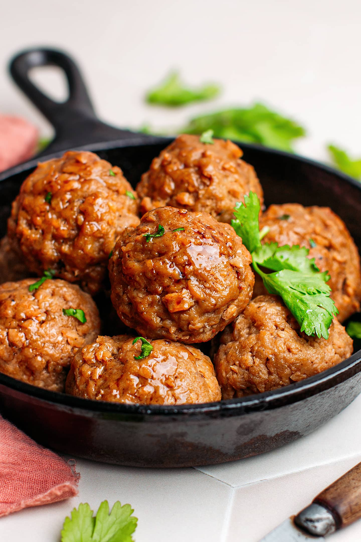 Close-up of vegan meatballs in a skillet.