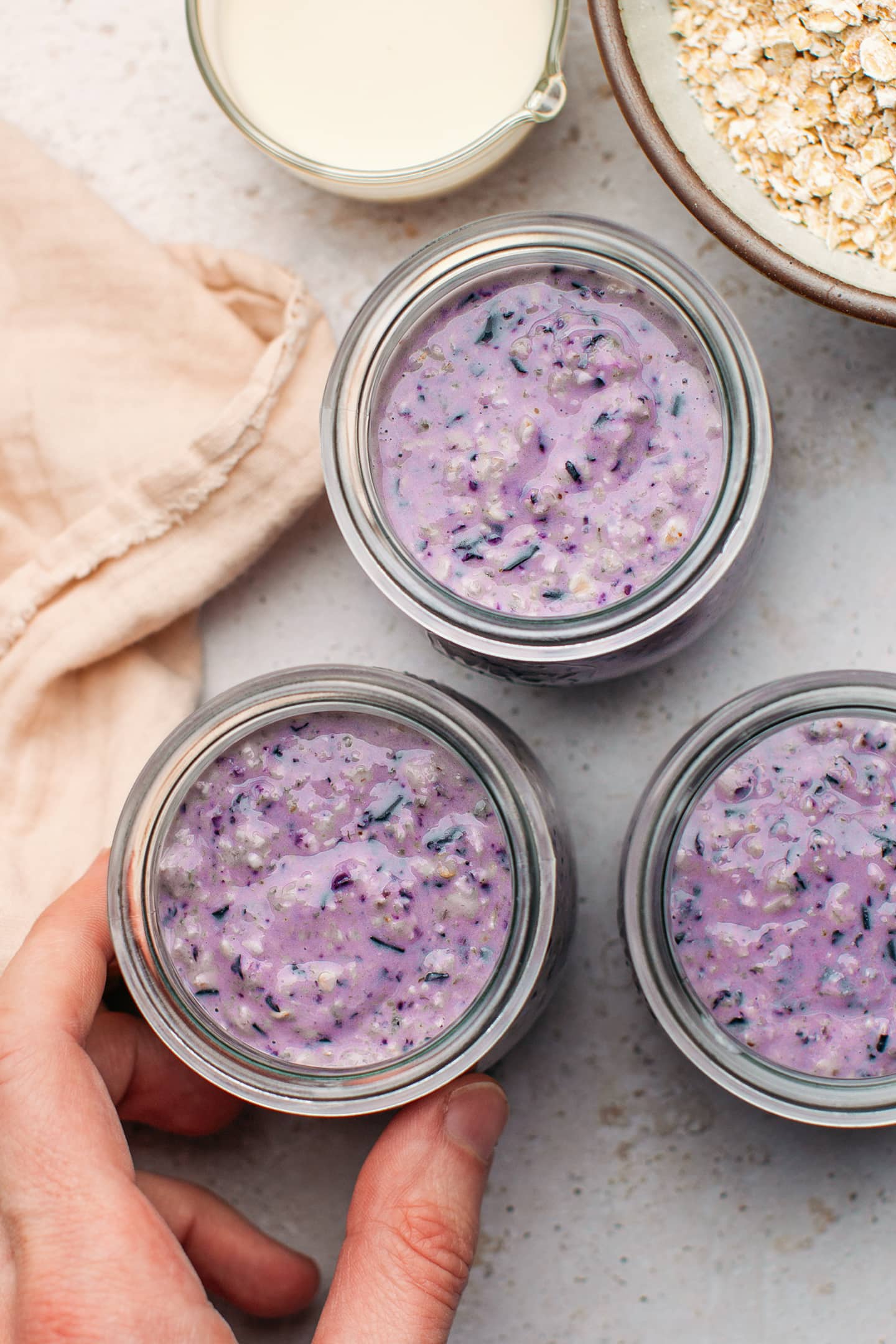 Three jars filled with blueberry oatmeal.