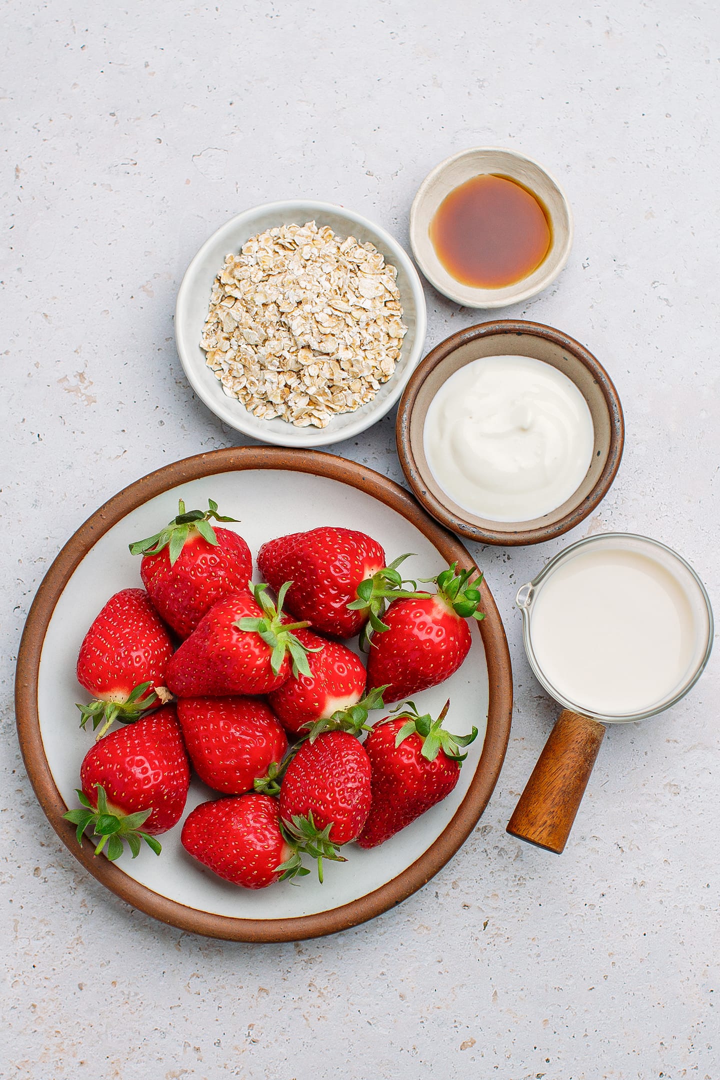 Ingredients like strawberries, oats, yogurt, and soy milk.