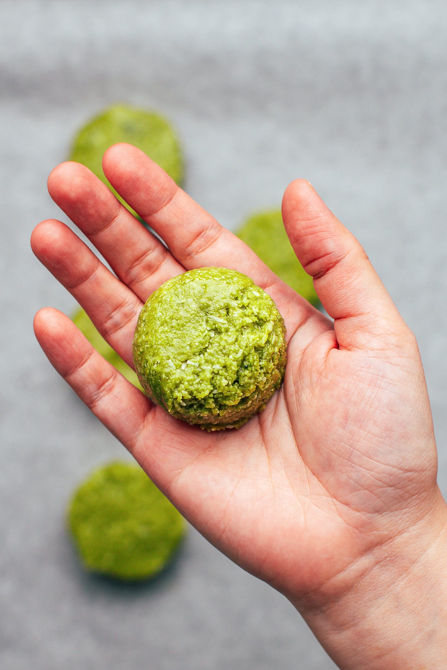 Holding a ball of matcha cookie dough.