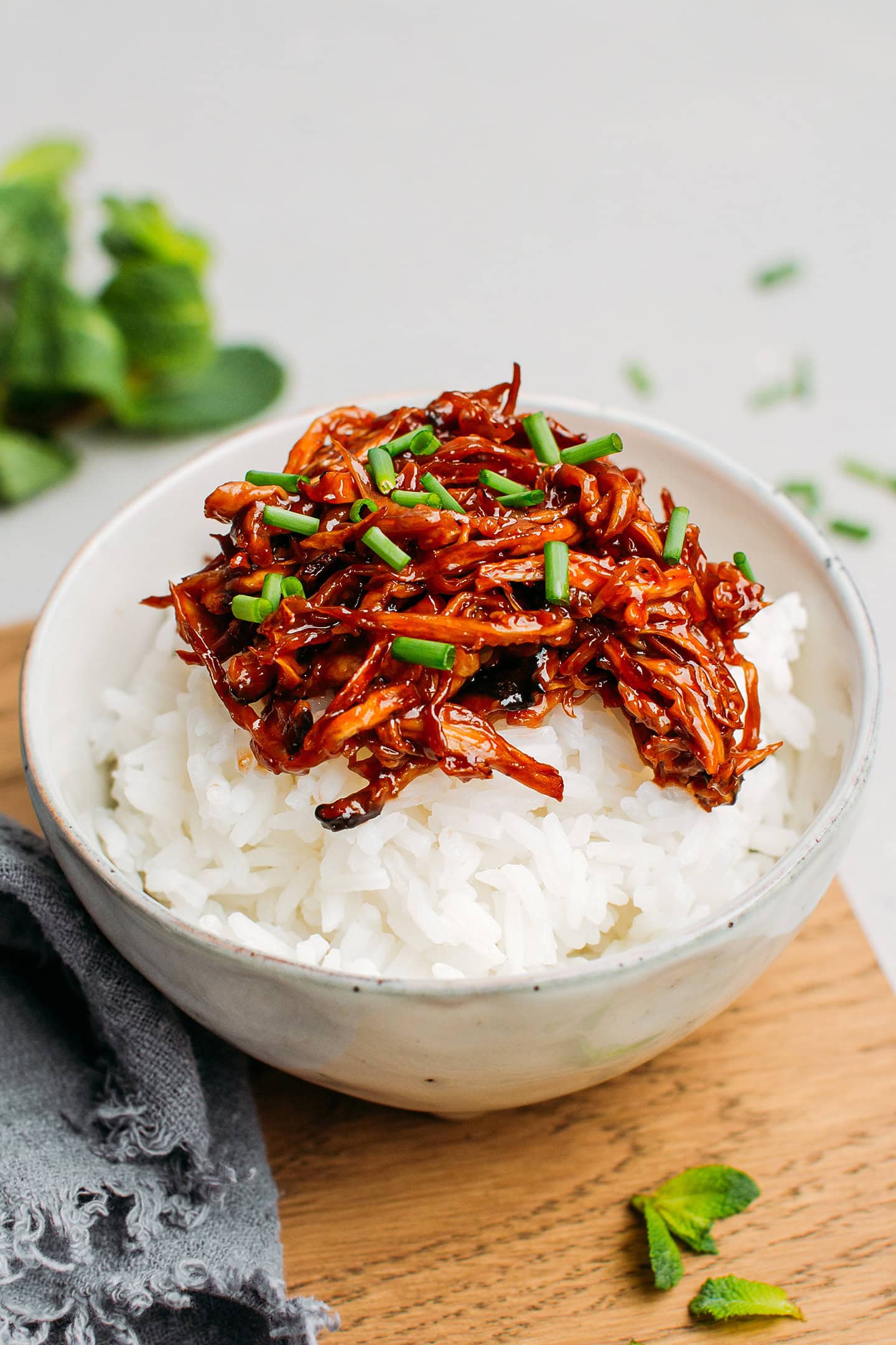 Shredded king oyster mushrooms glazed with barbecue sauce on top of white rice.