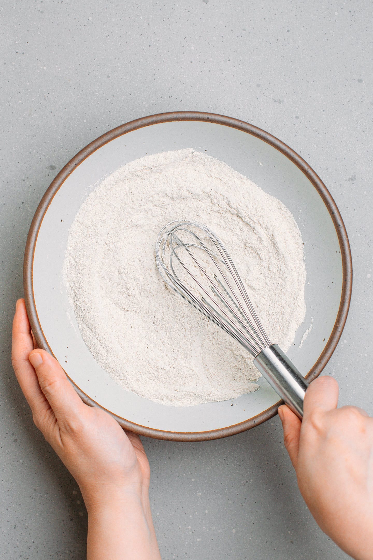 Whisking buckwheat flour, sugar, baking powder, and salt in a mixing bowl.