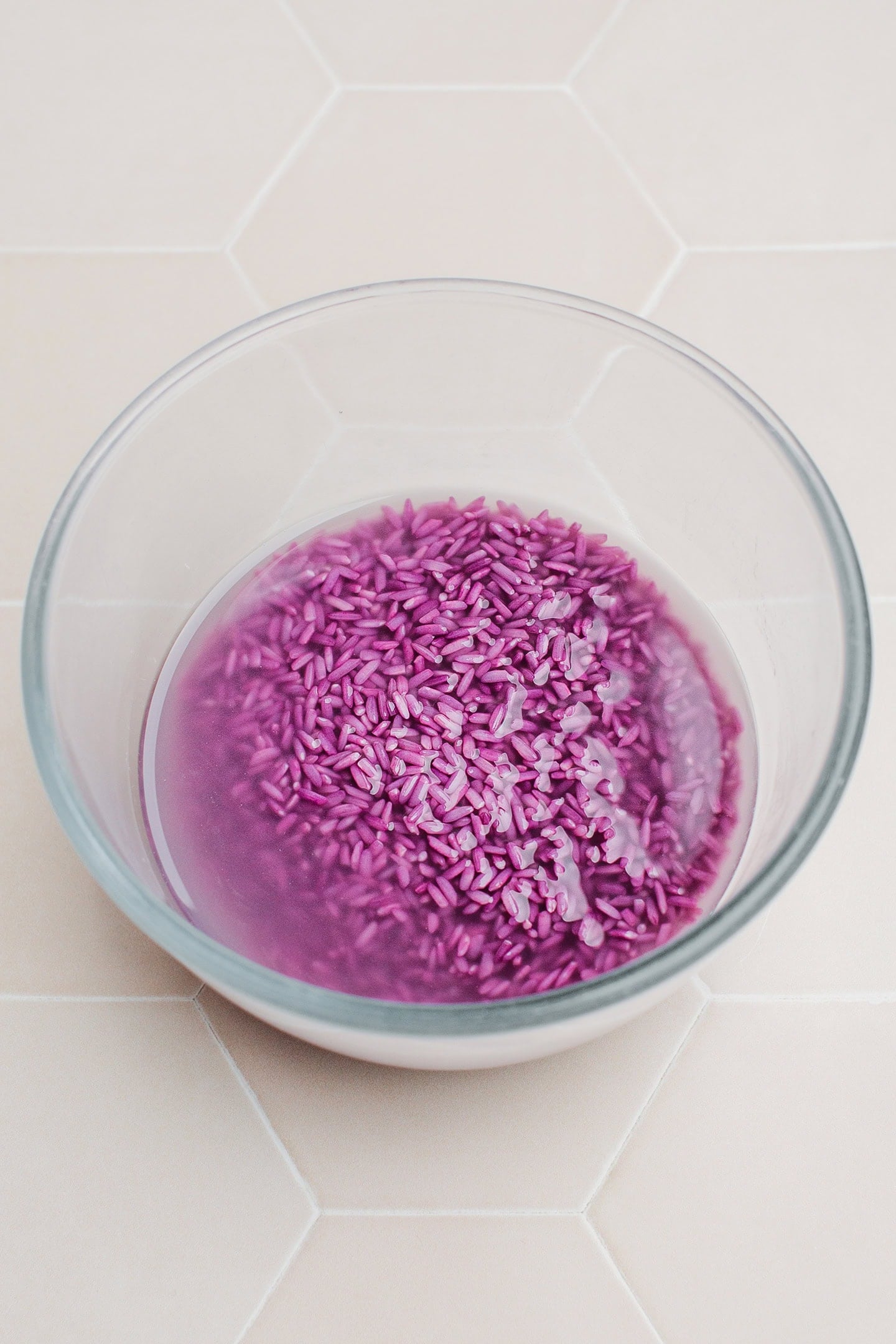 Sticky rice soaked with ube powder in a bowl.