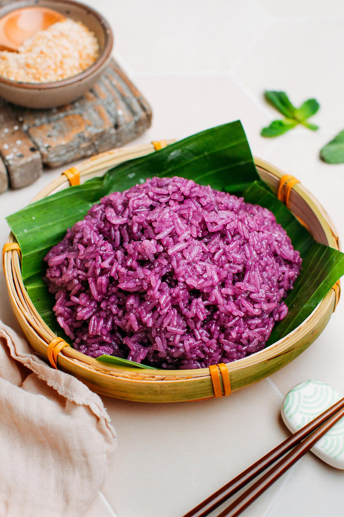 Cooked purple sticky rice on top of a banana leaf.