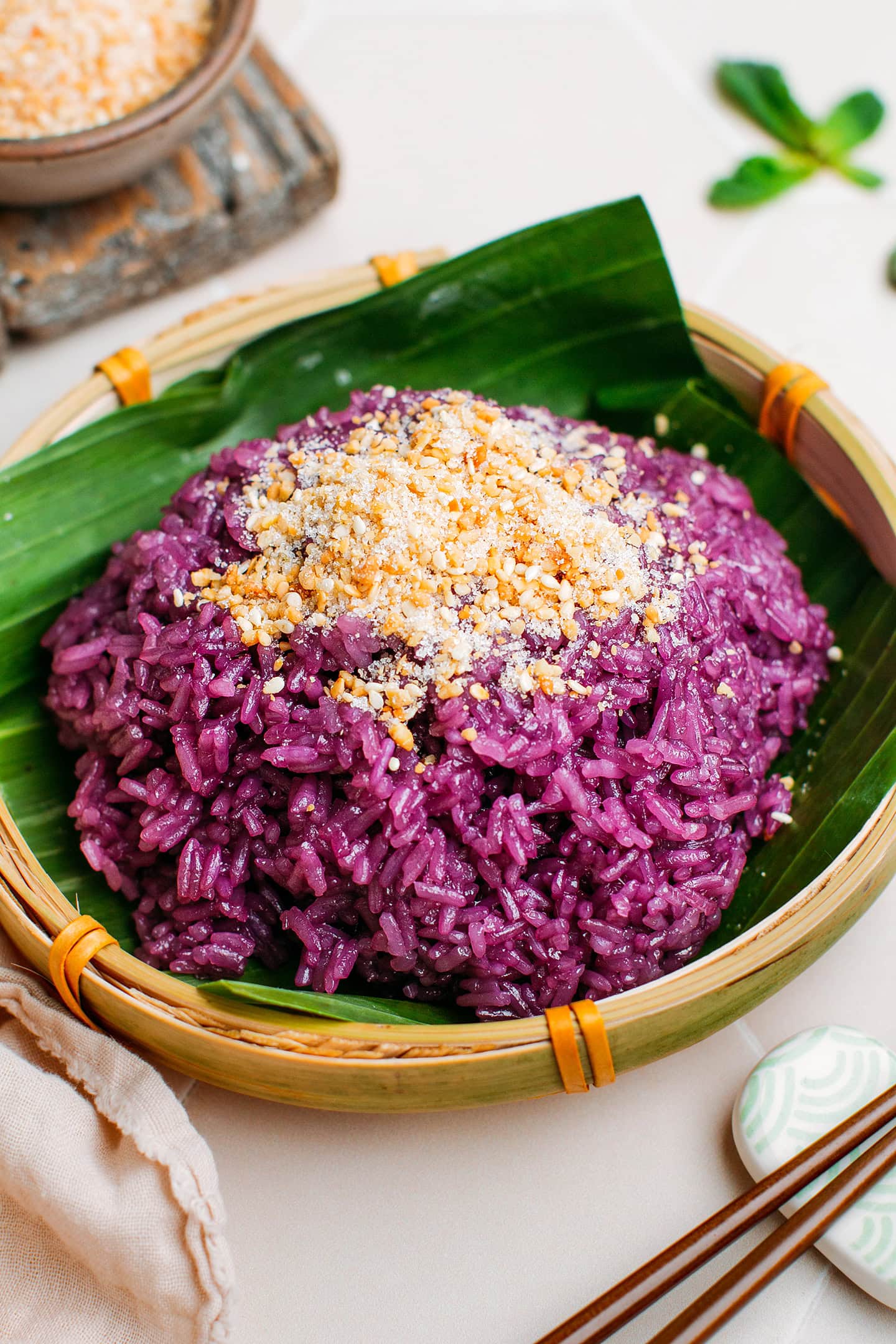 Purple sticky rice topped with ground peanuts and toasted sesame seeds.