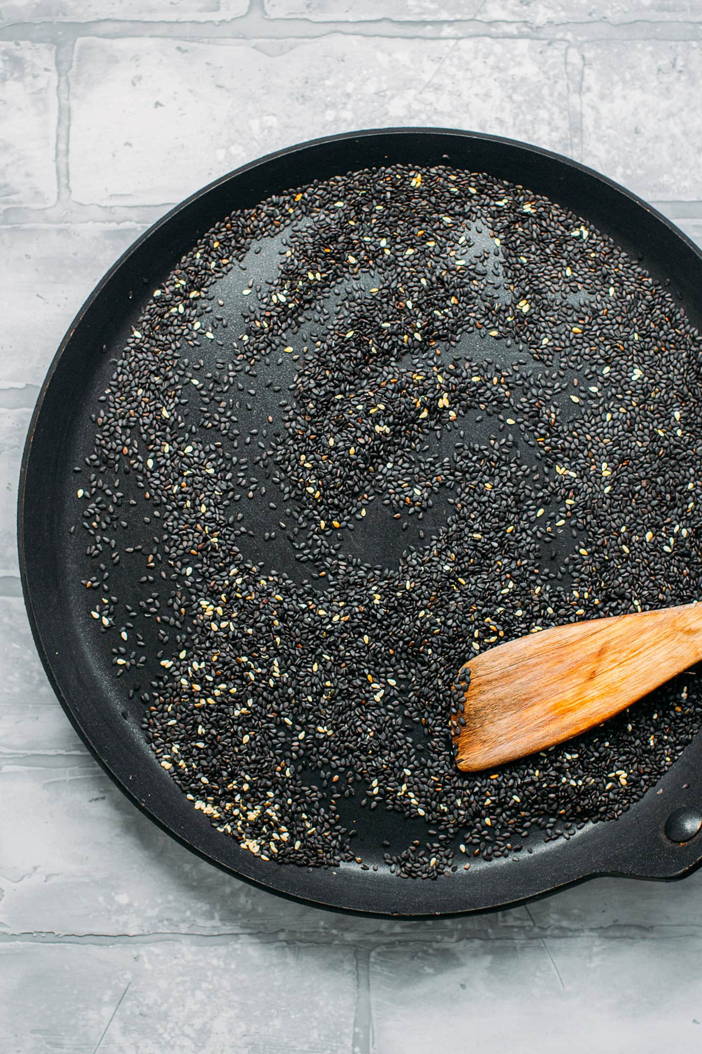 Black and white sesame seeds in a skillet.