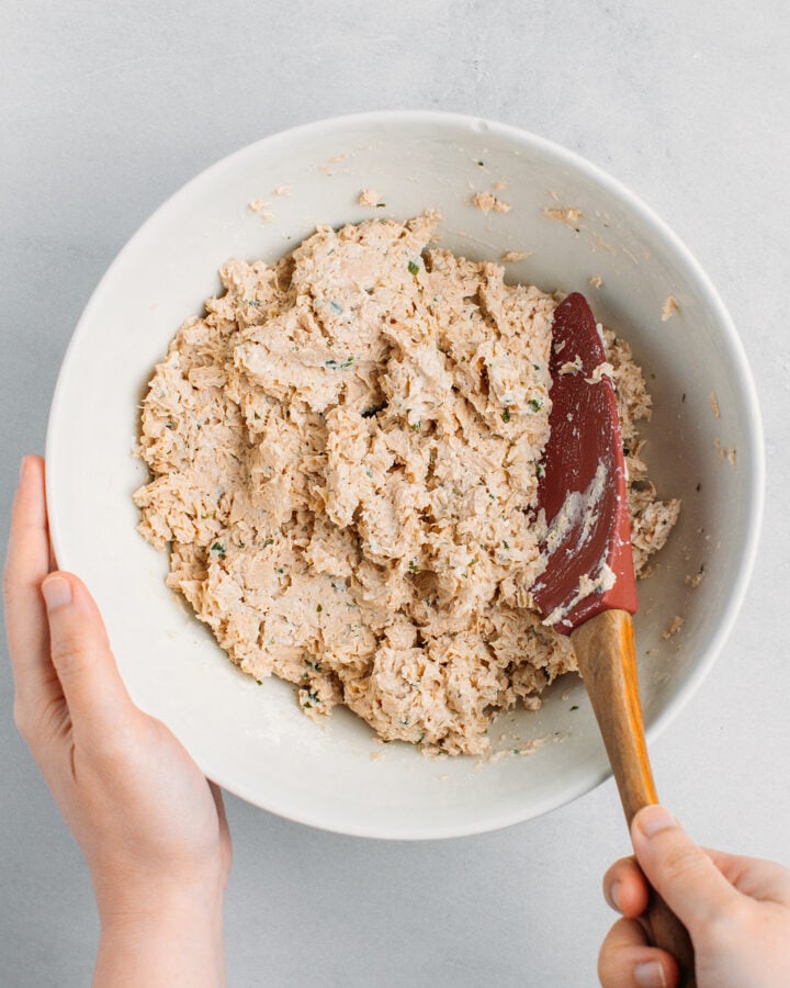 Flaky mixture made of tofu and textured vegetable protein in a mixing bowl.