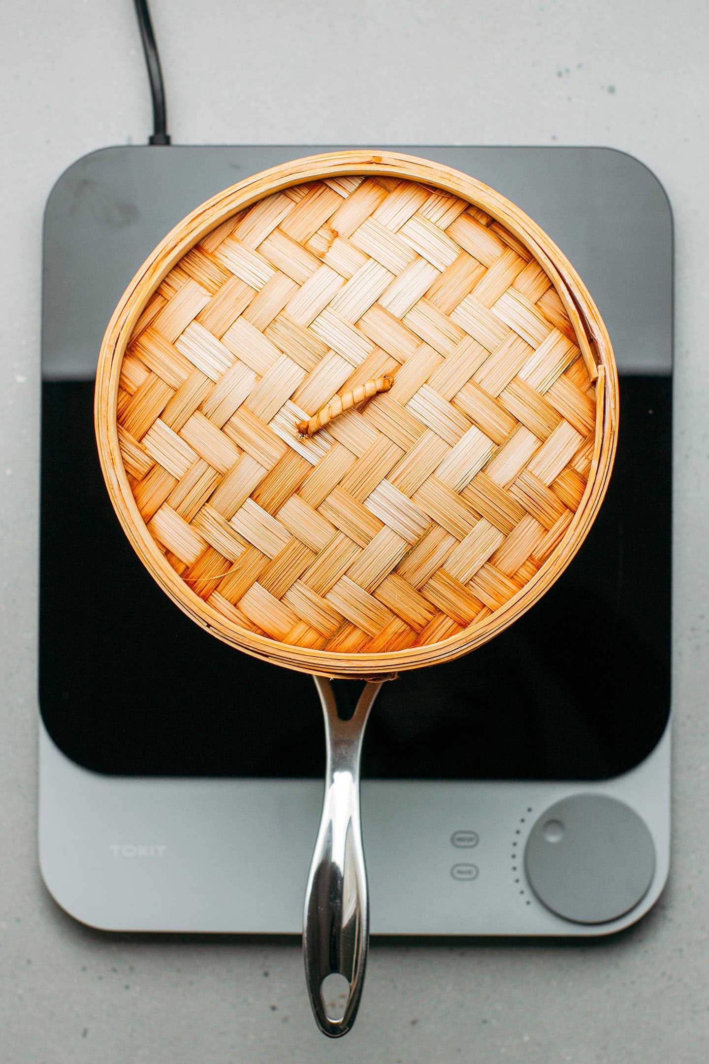 Bamboo steamer on top of a saucepan.