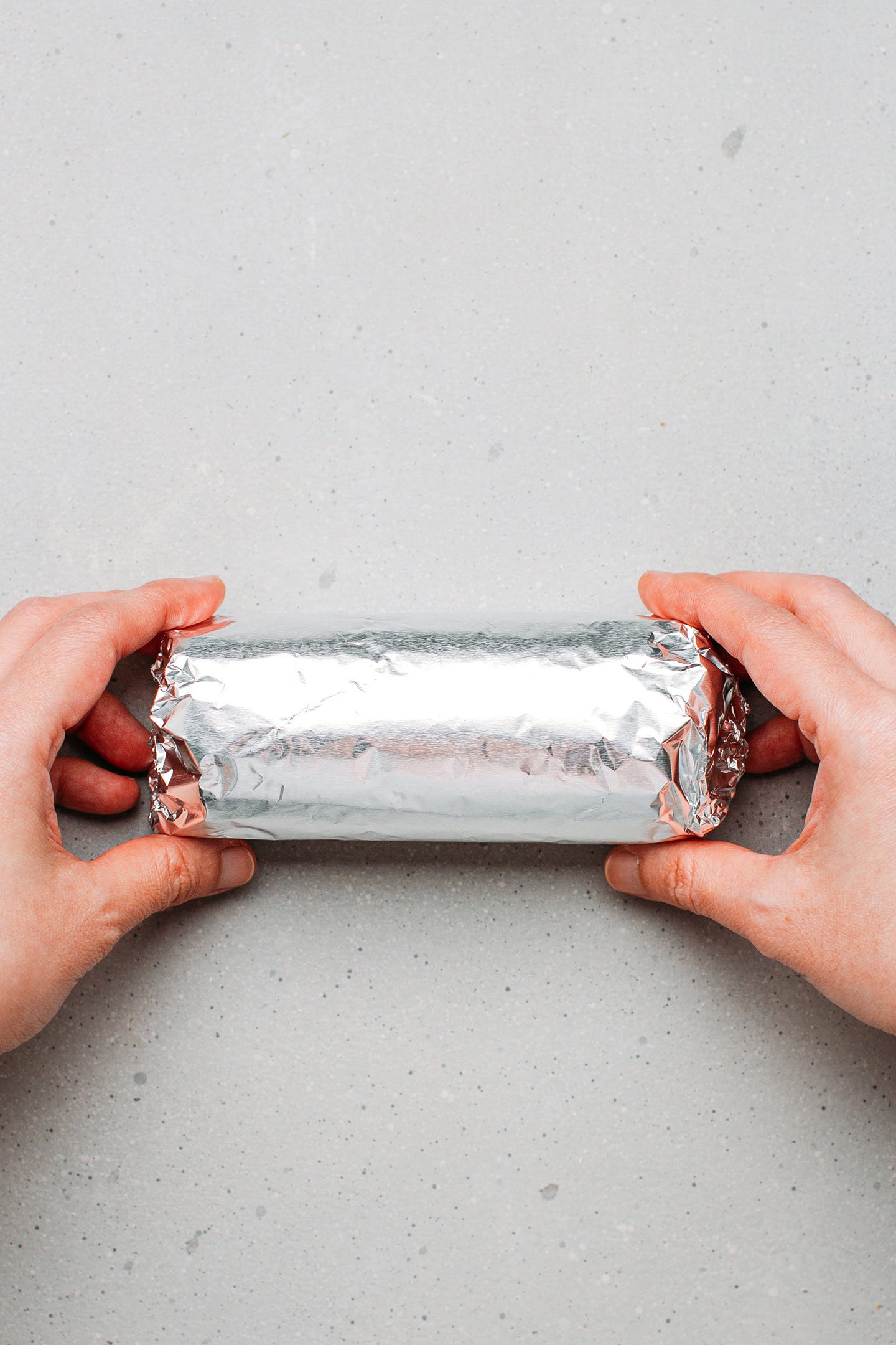 Wrapping seitan loaf in aluminum foil.