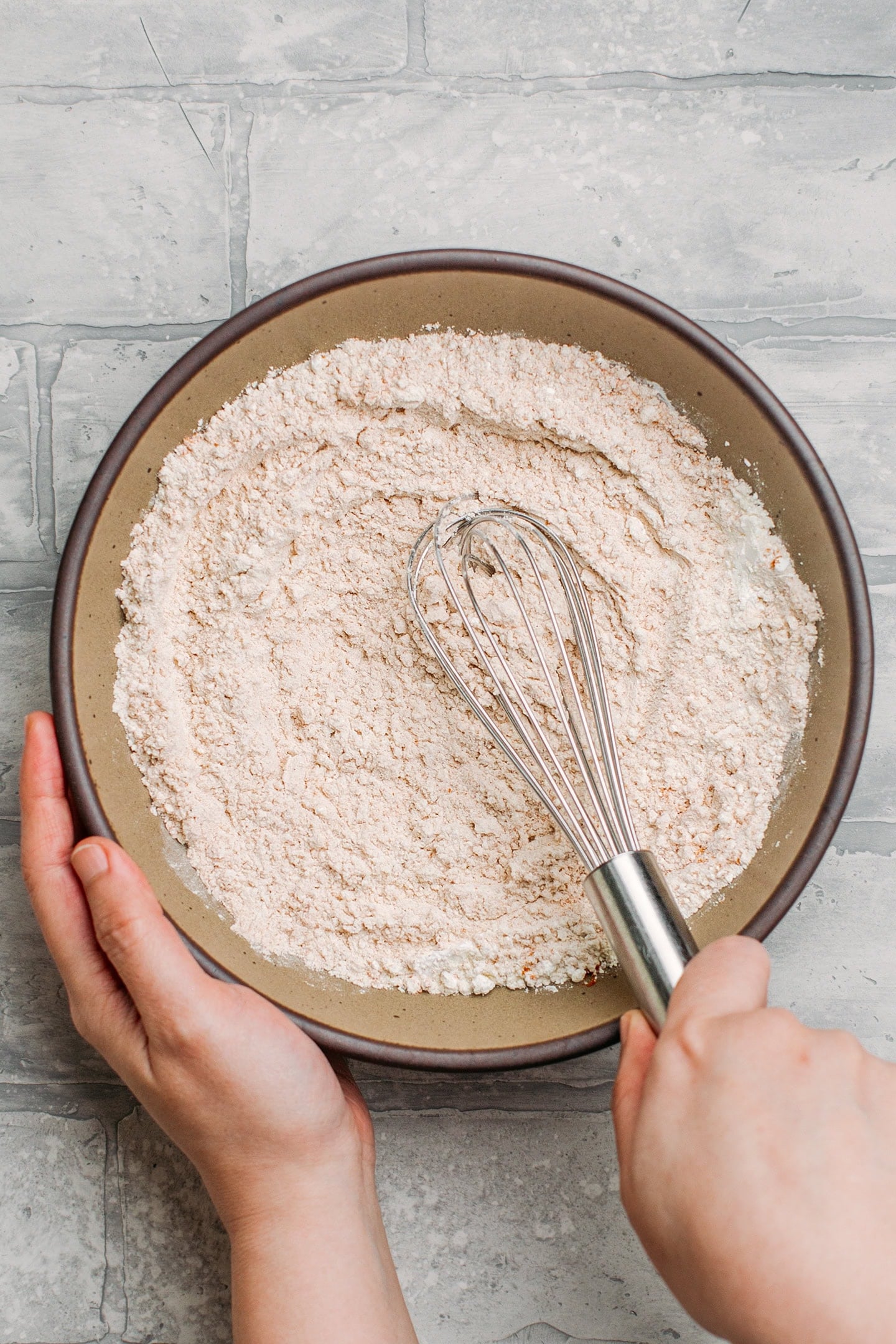 Whisking flour with curry powder and salt.
