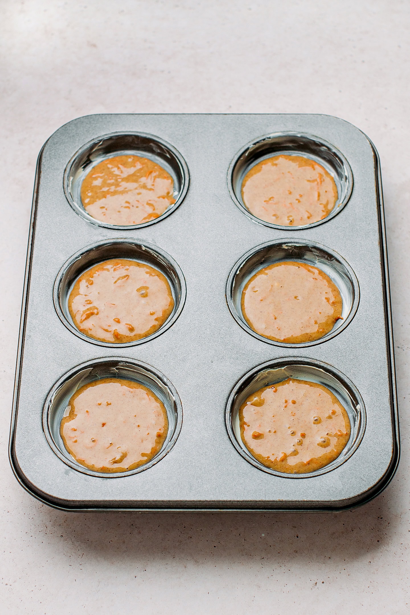 Muffin pan filled with batter.