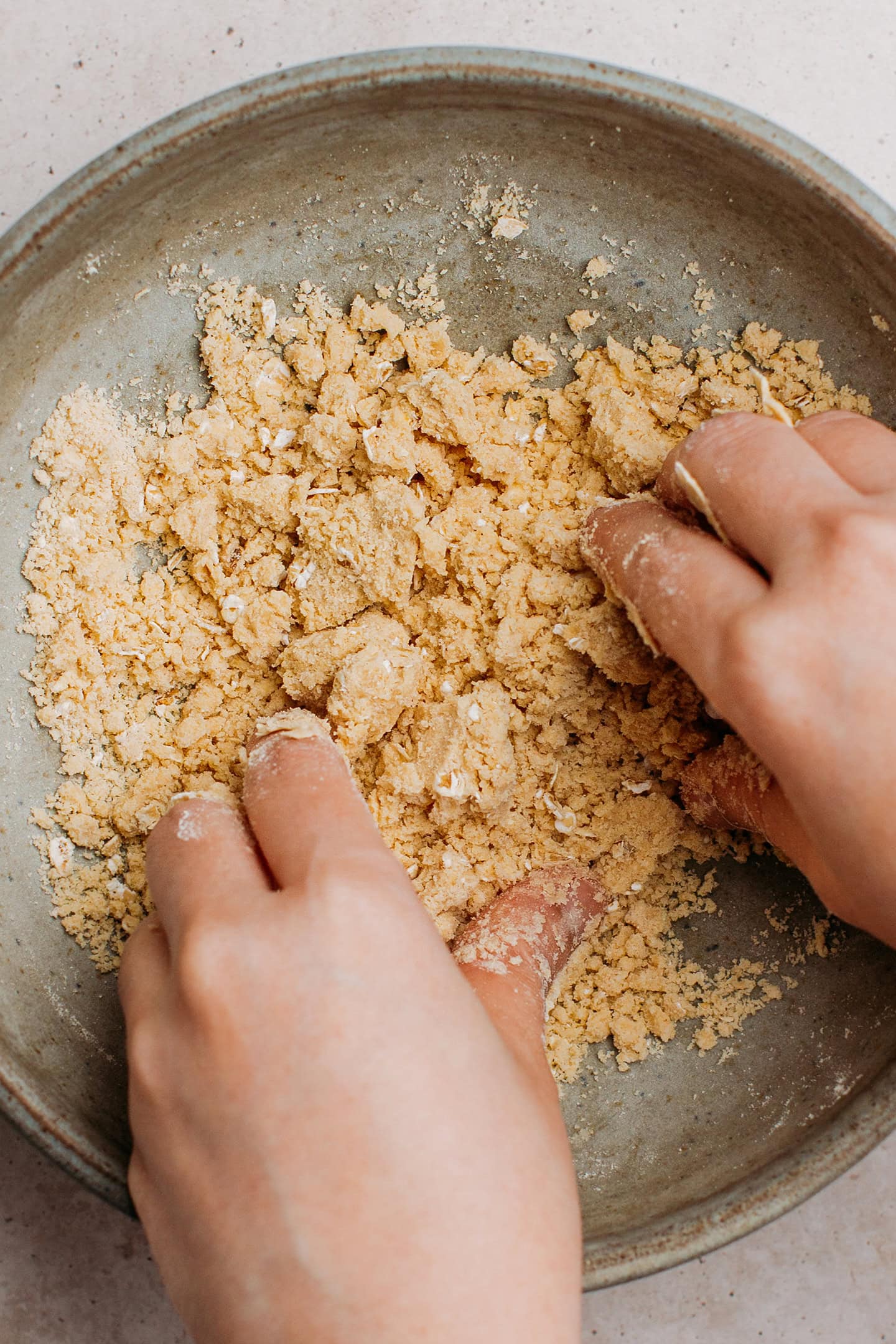 Making a muffin crumb topping in a small bowl.