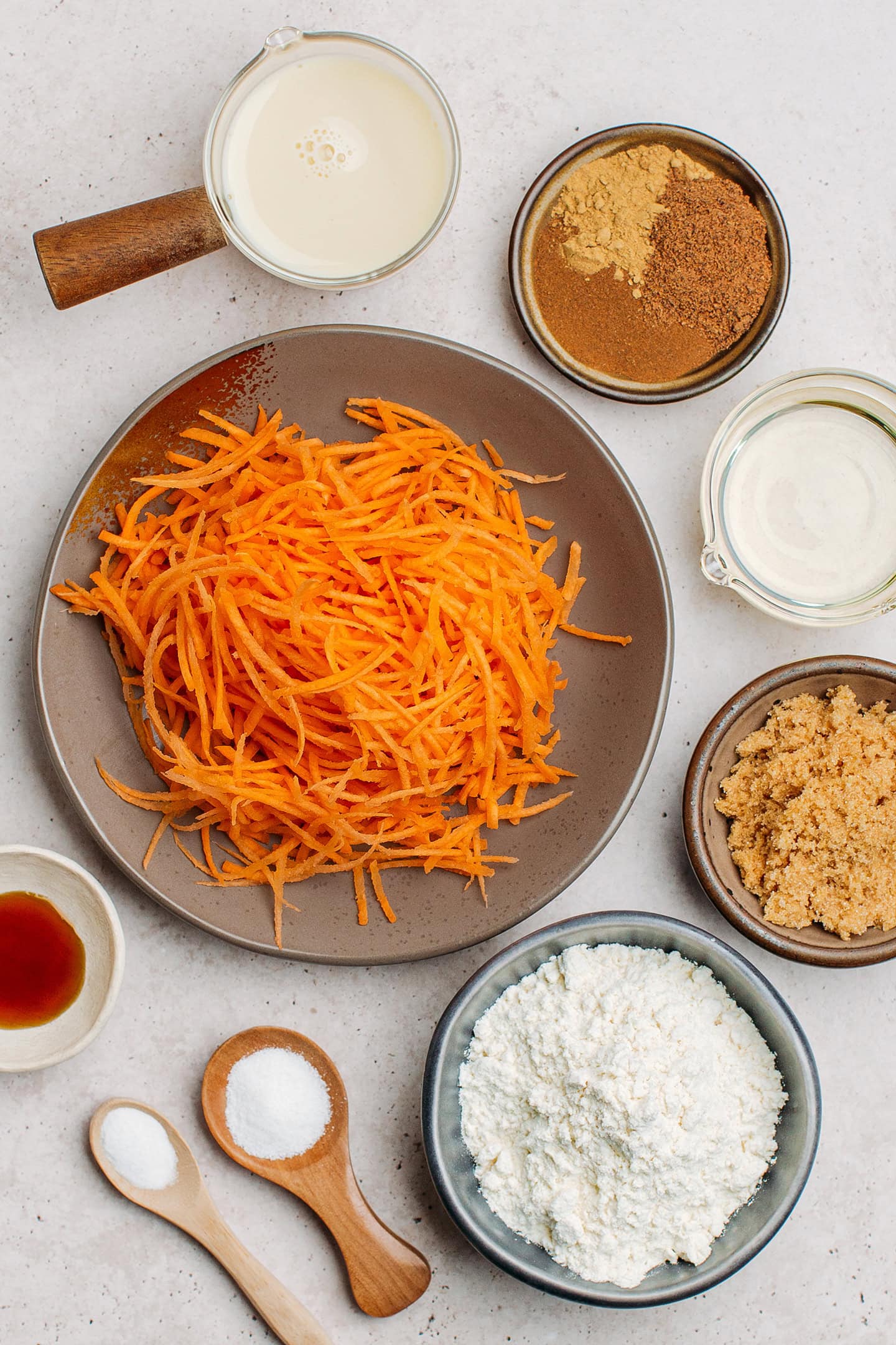 Ingredients like grated carrots, brown sugar, oil, sugar, and flour.