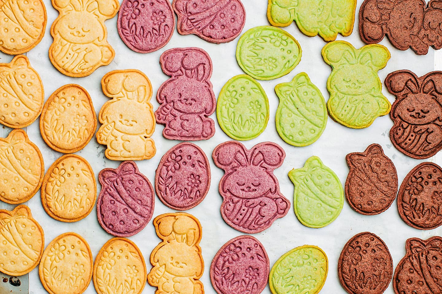 Colorful sugar cookies on a baking sheet.