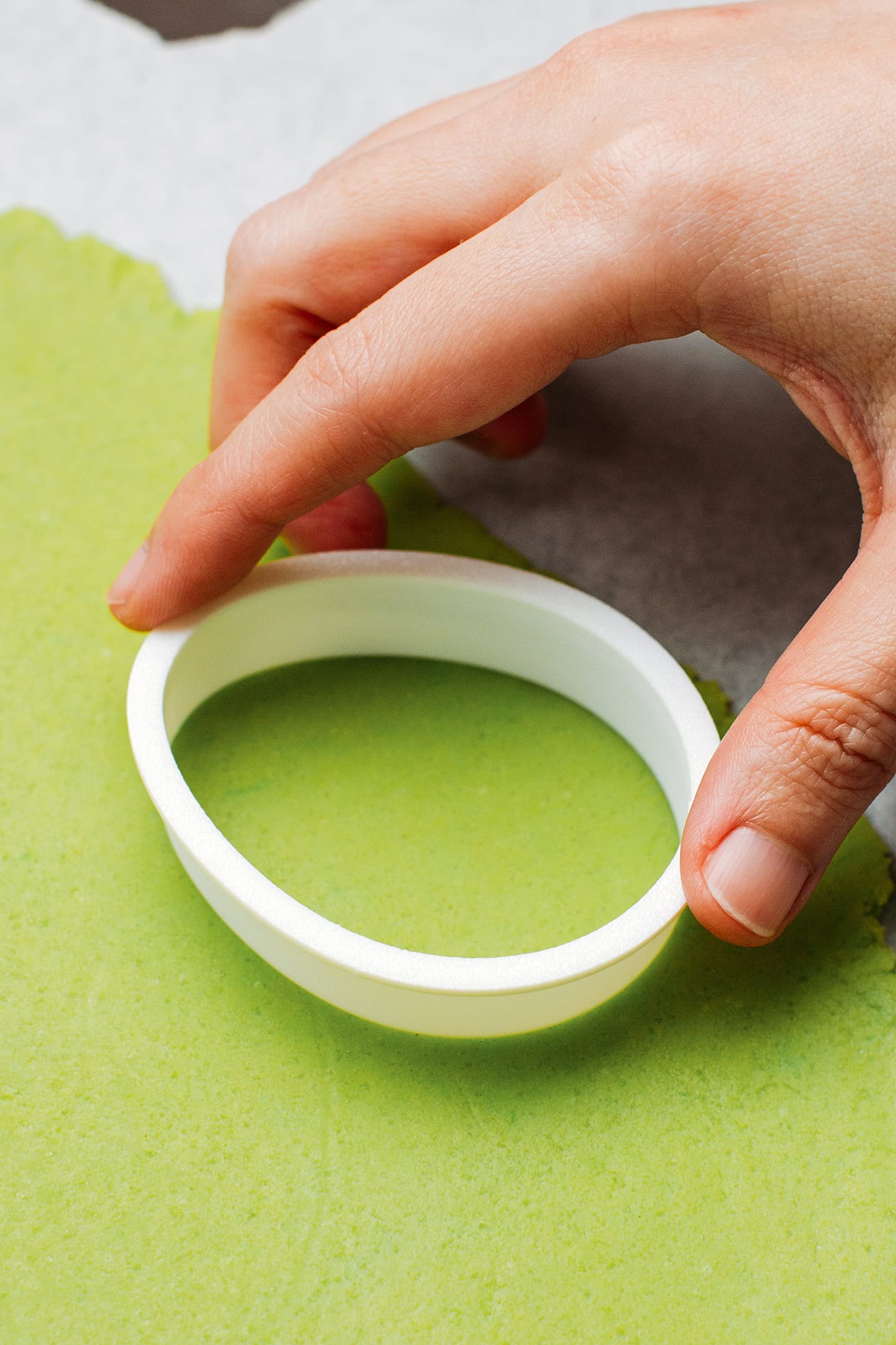 Cutting out an egg-shaped cookie.