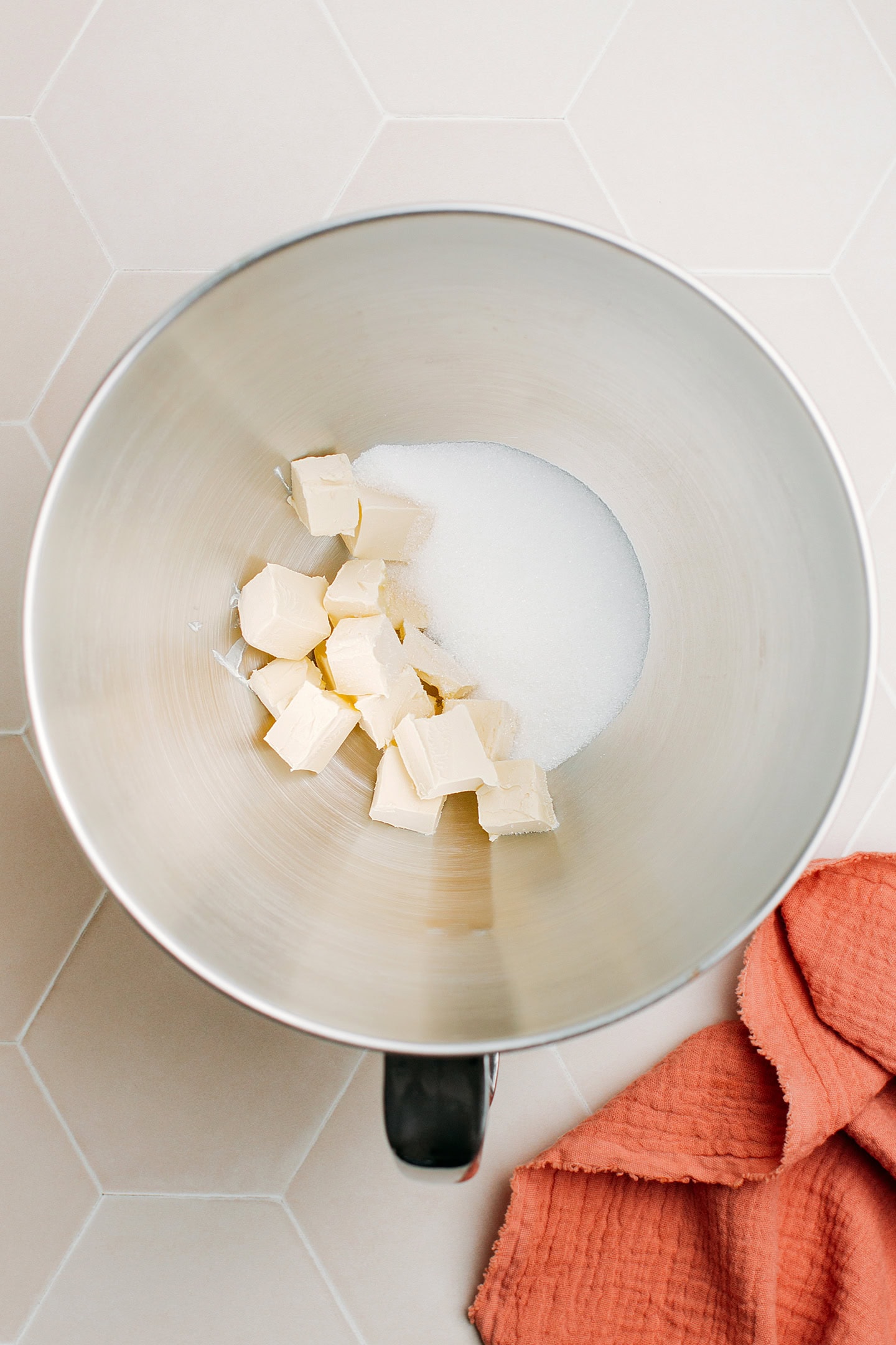 Diced butter and sugar in the bowl of a stand mixer.