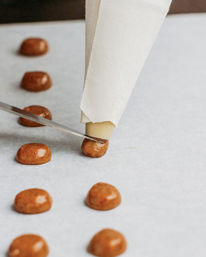 Cutting a ball of dough using a knife to make cereal.
