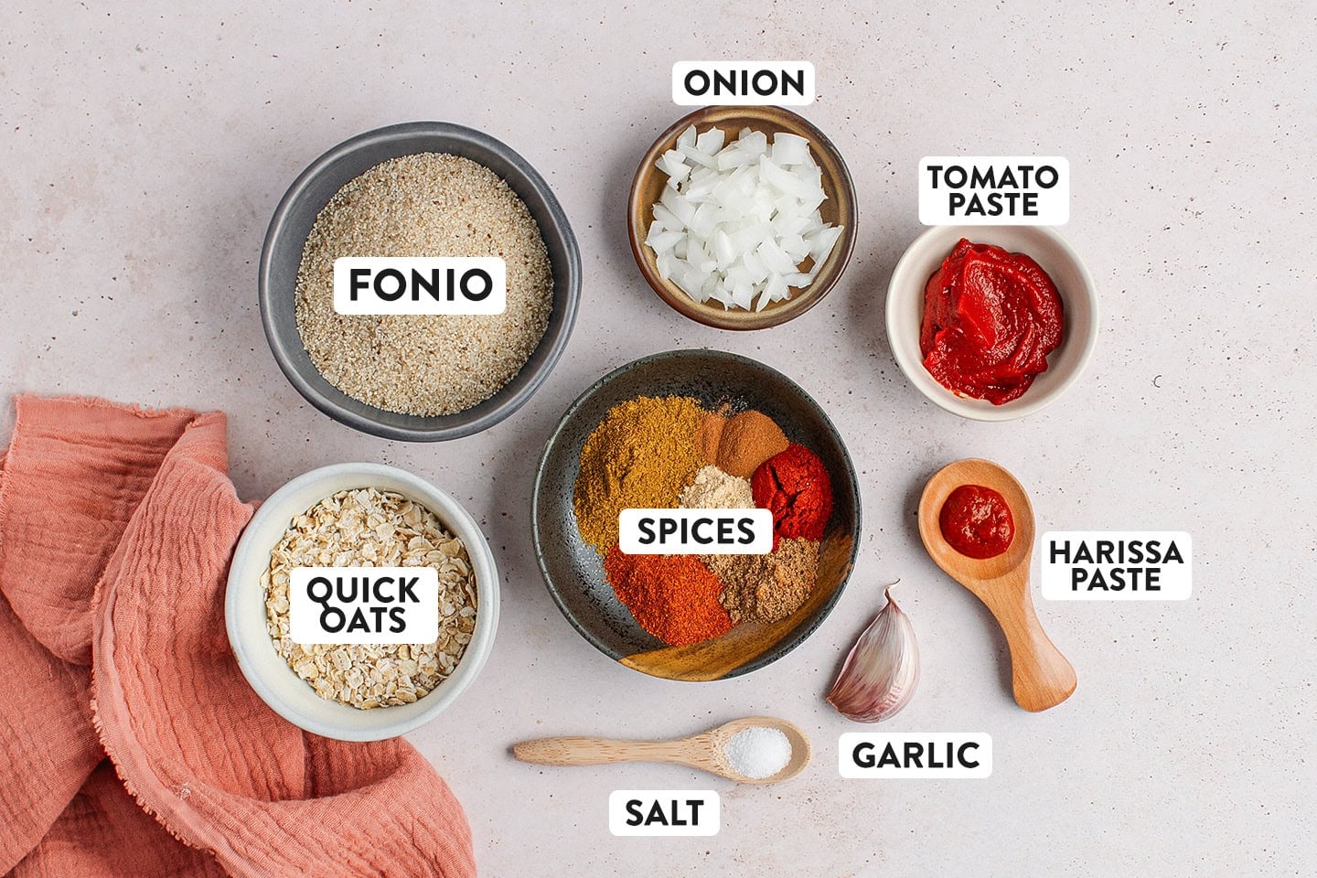 Ingredients like fonio, spices, tomato paste, and oats.