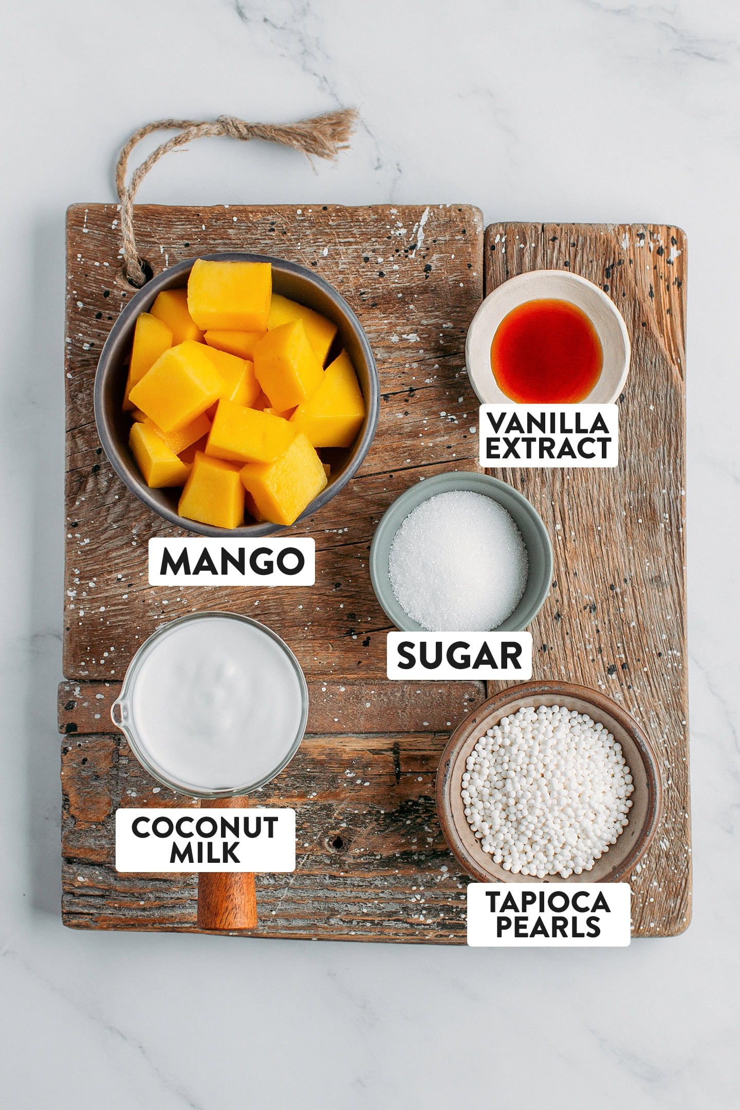 Ingredients like mango, tapioca pearls, coconut milk, sugar, and vanilla extract.
