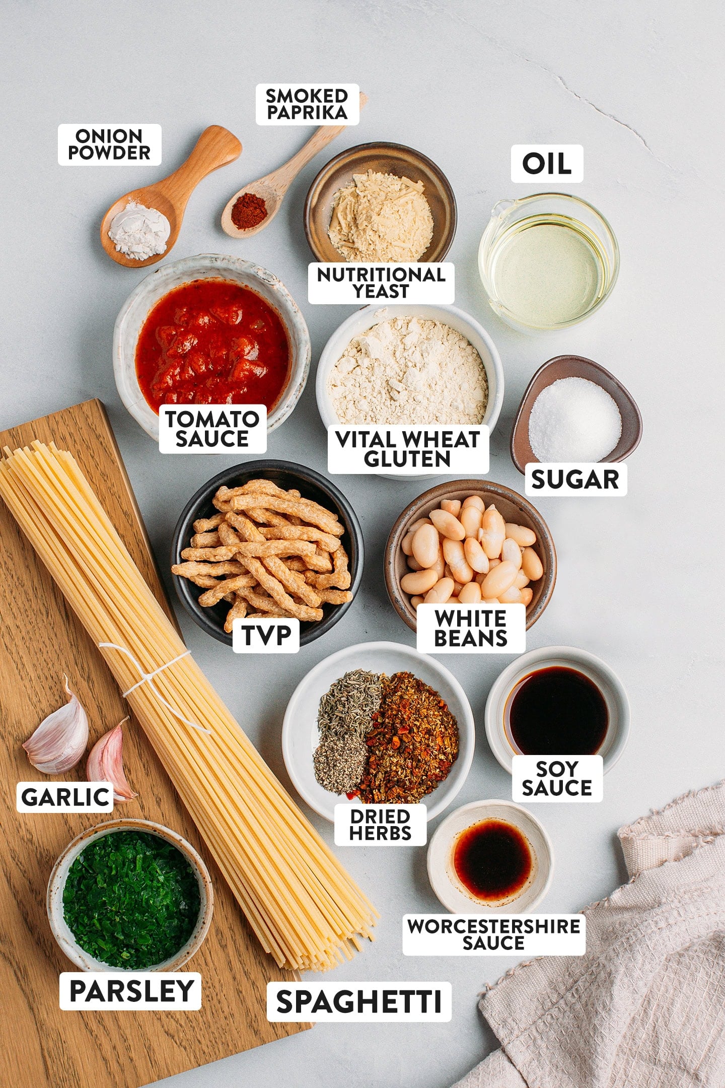 Ingredients like spaghetti, tvp, white beans, vital wheat gluten, and tomato sauce.