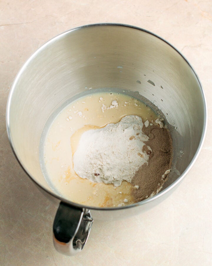 Soy milk, flour, and sugar in a stand mixer bowl.