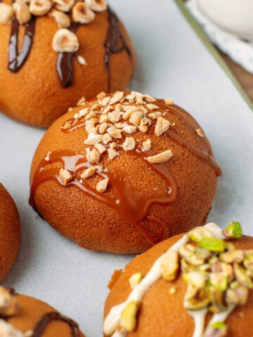 Close up of a Papparoti bun drizzled with caramel sauce and topped with crushed peanuts.