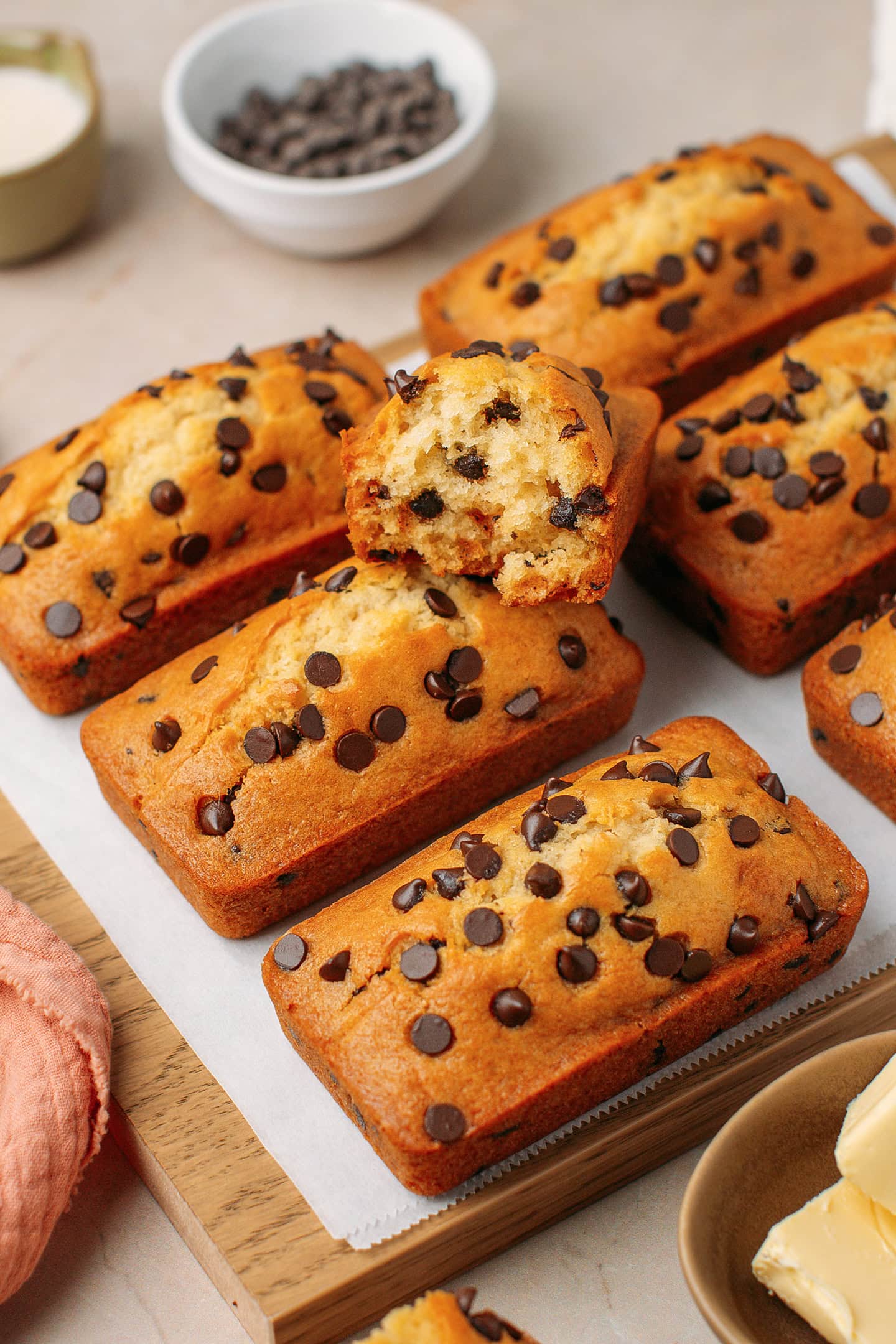 Half of a mini loaf cake sitting on six other loaf cakes.