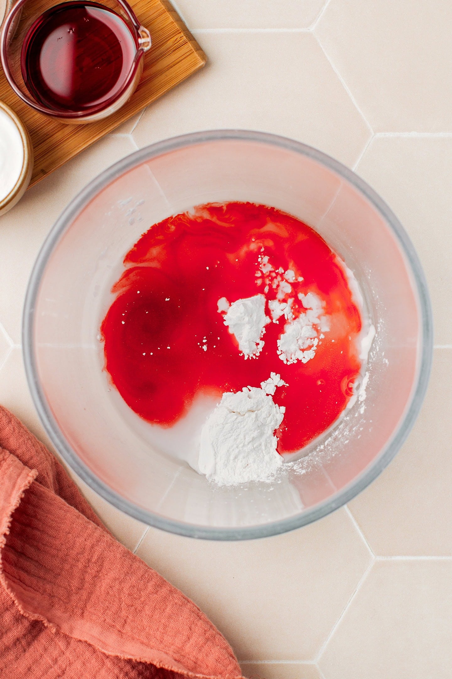 Red food coloring, water, and tapioca starch in a glass bowl.