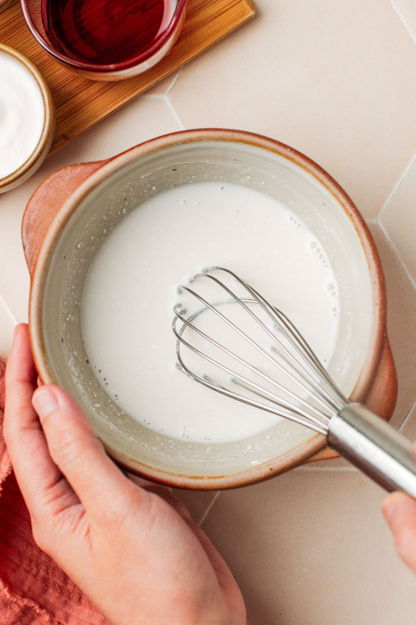 Whisking tapioca starch and rice flour with coconut milk in a small bowl.