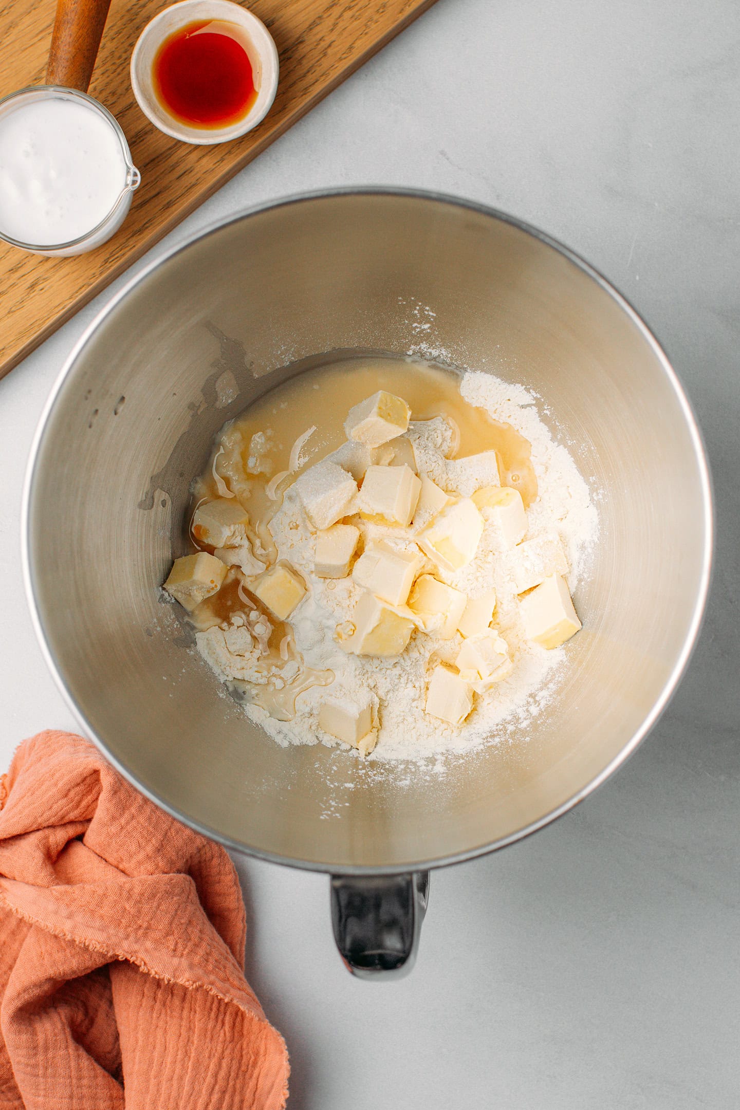 Diced butter, flour, and water in a stand mixer bowl.