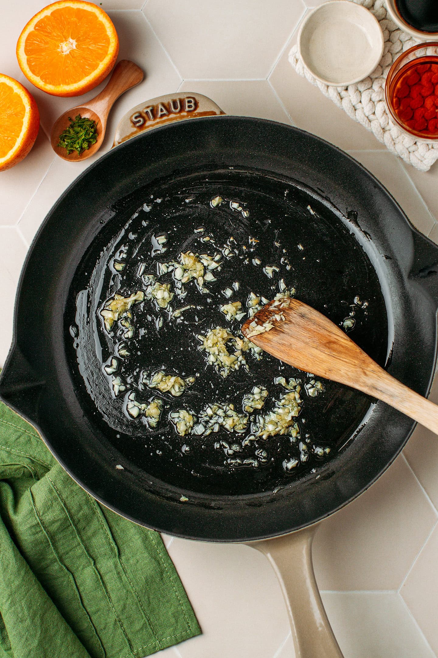 Sautéed minced garlic and ginger in a skillet.