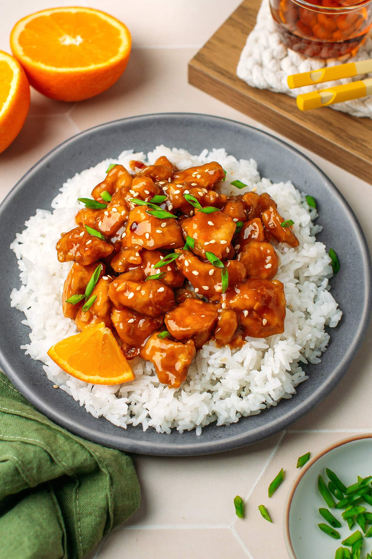Blue plate filled with white rice and saucy orange tofu.