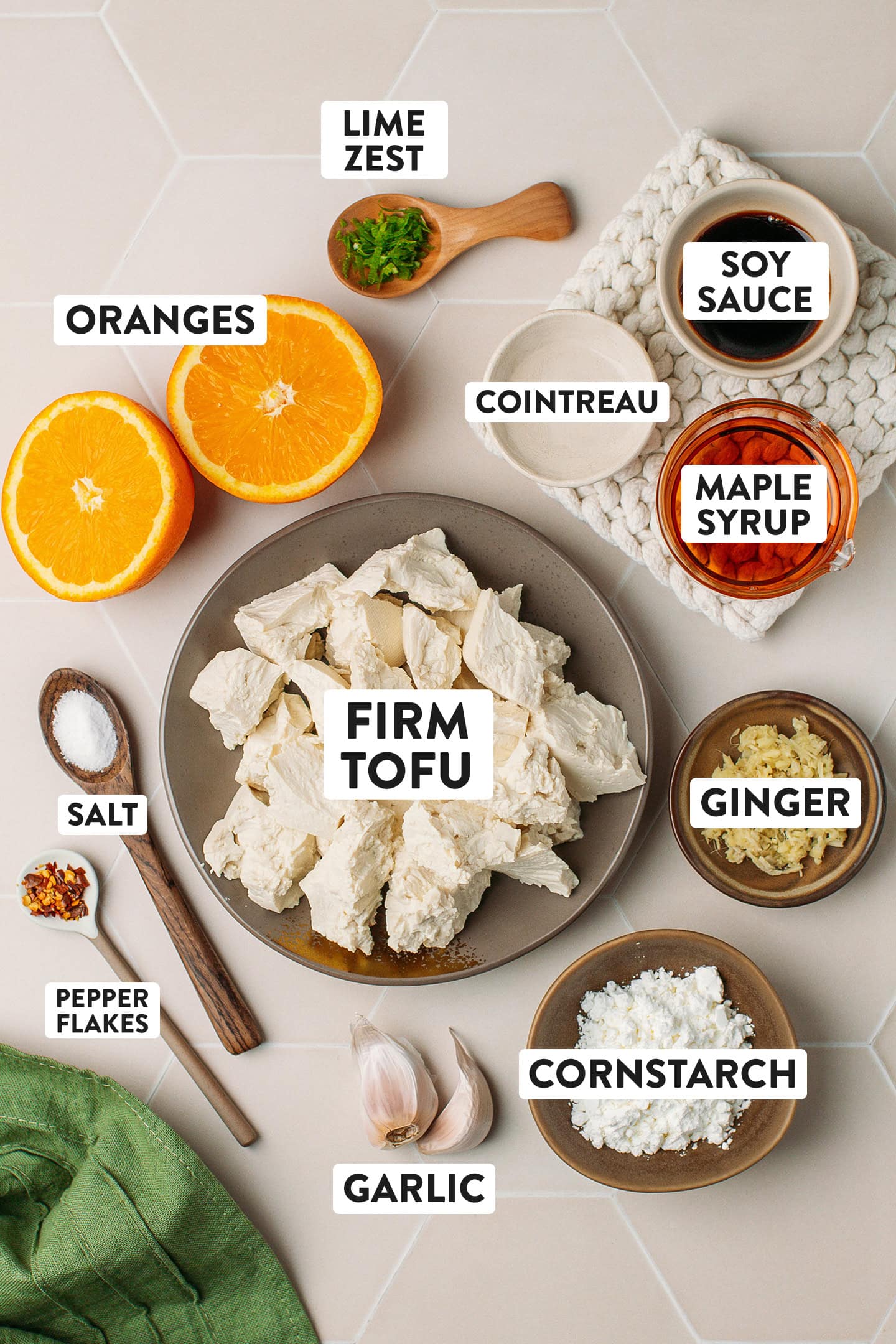Ingredients like oranges, tofu, soy sauce, maple syrup, and cornstarch.