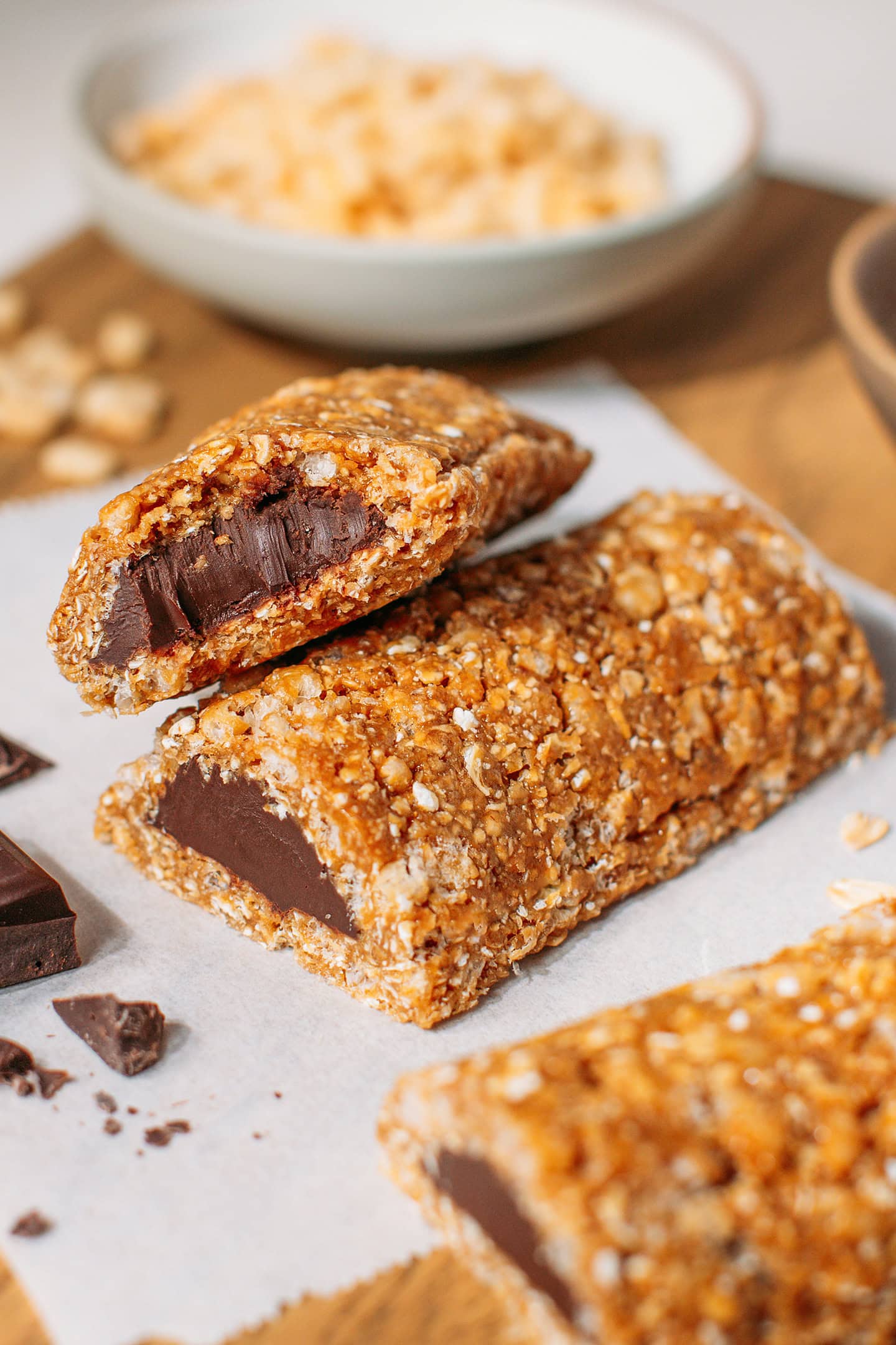 Two granola bars filled with chocolate hazelnut filling on a wooden board.