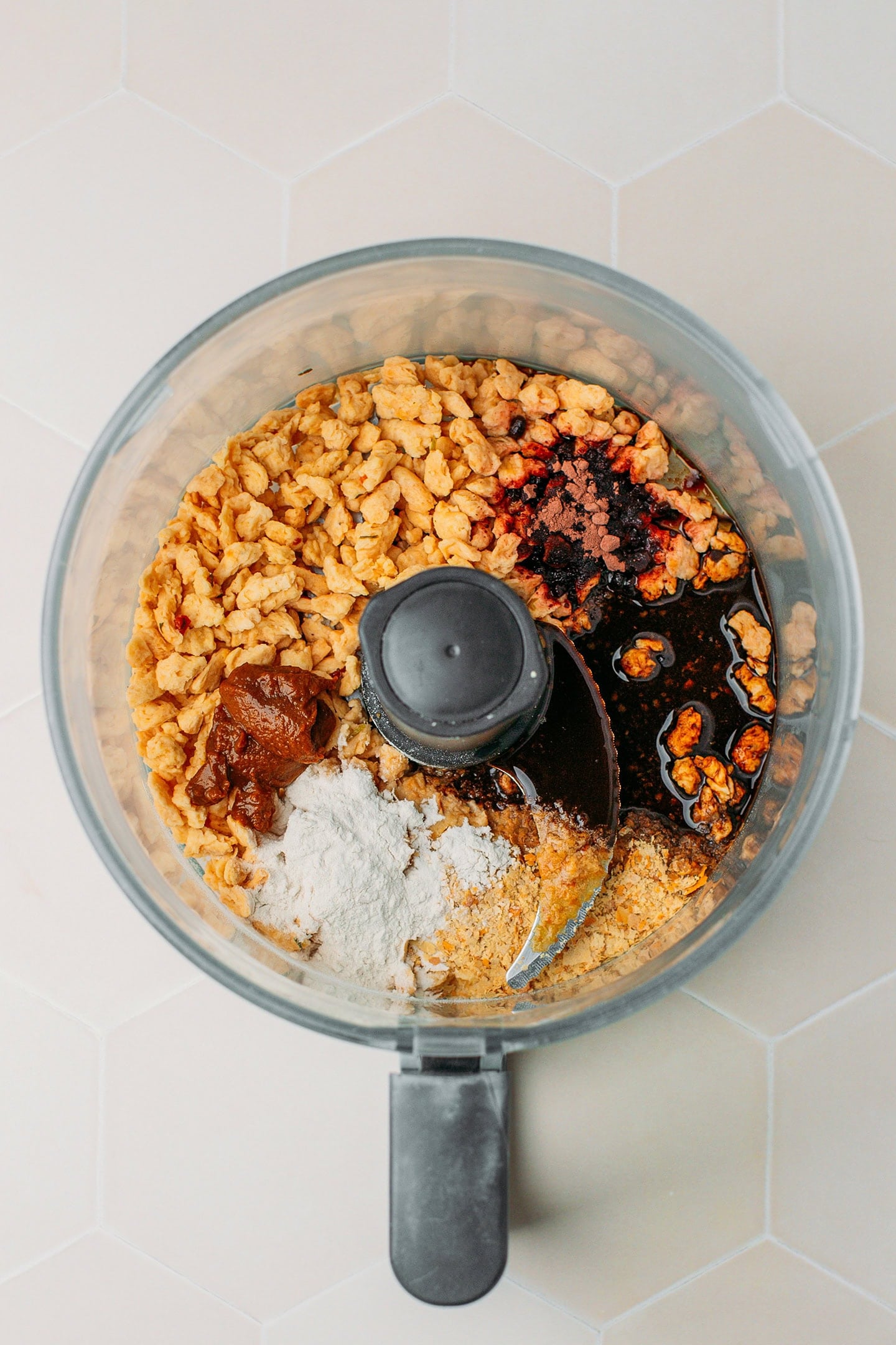 TVP chunks, nutritional yeast, miso, and dark soy sauce in a food processor.