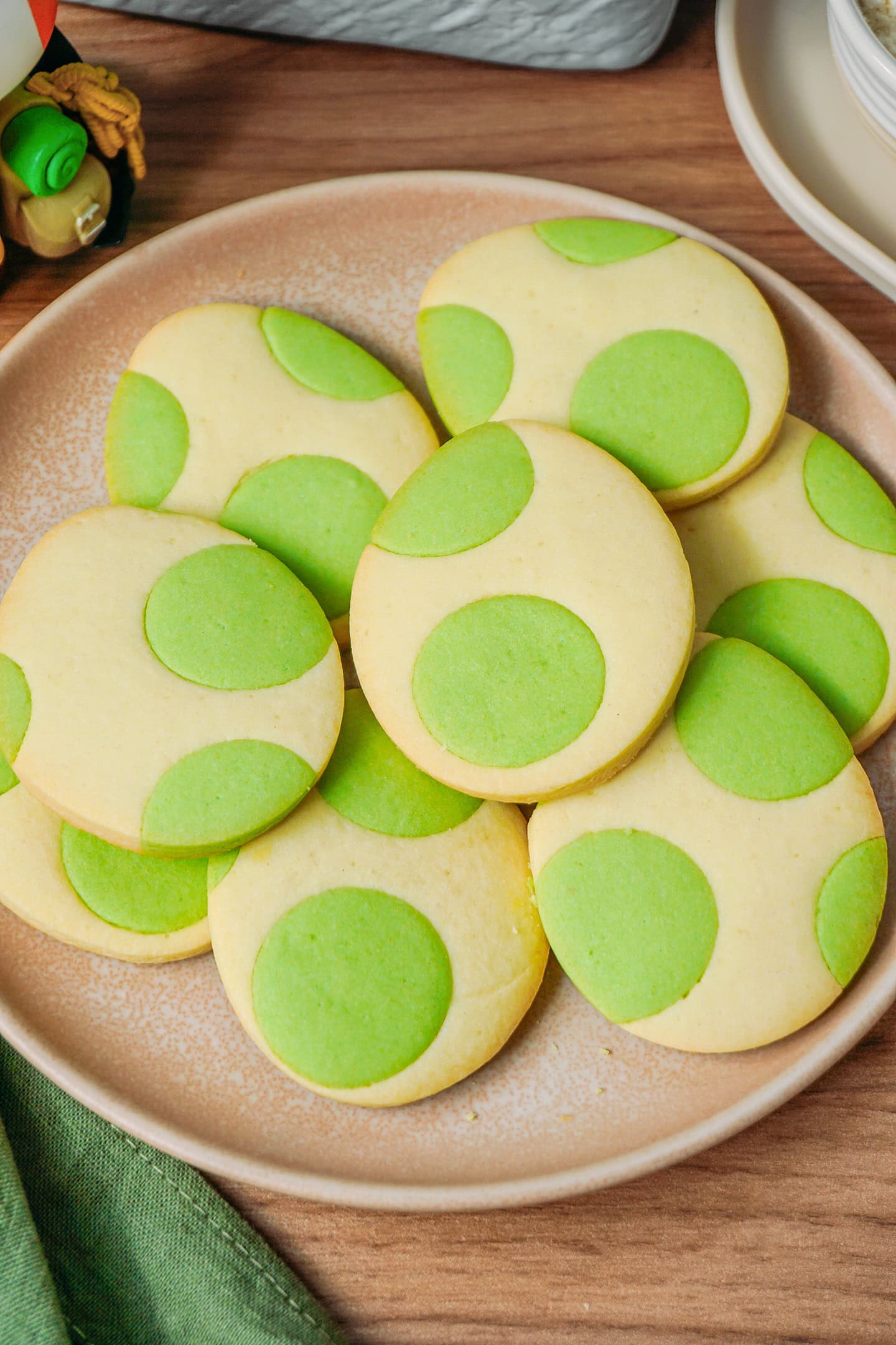 Cookies in the shape of Yoshi's eggs on a plate.