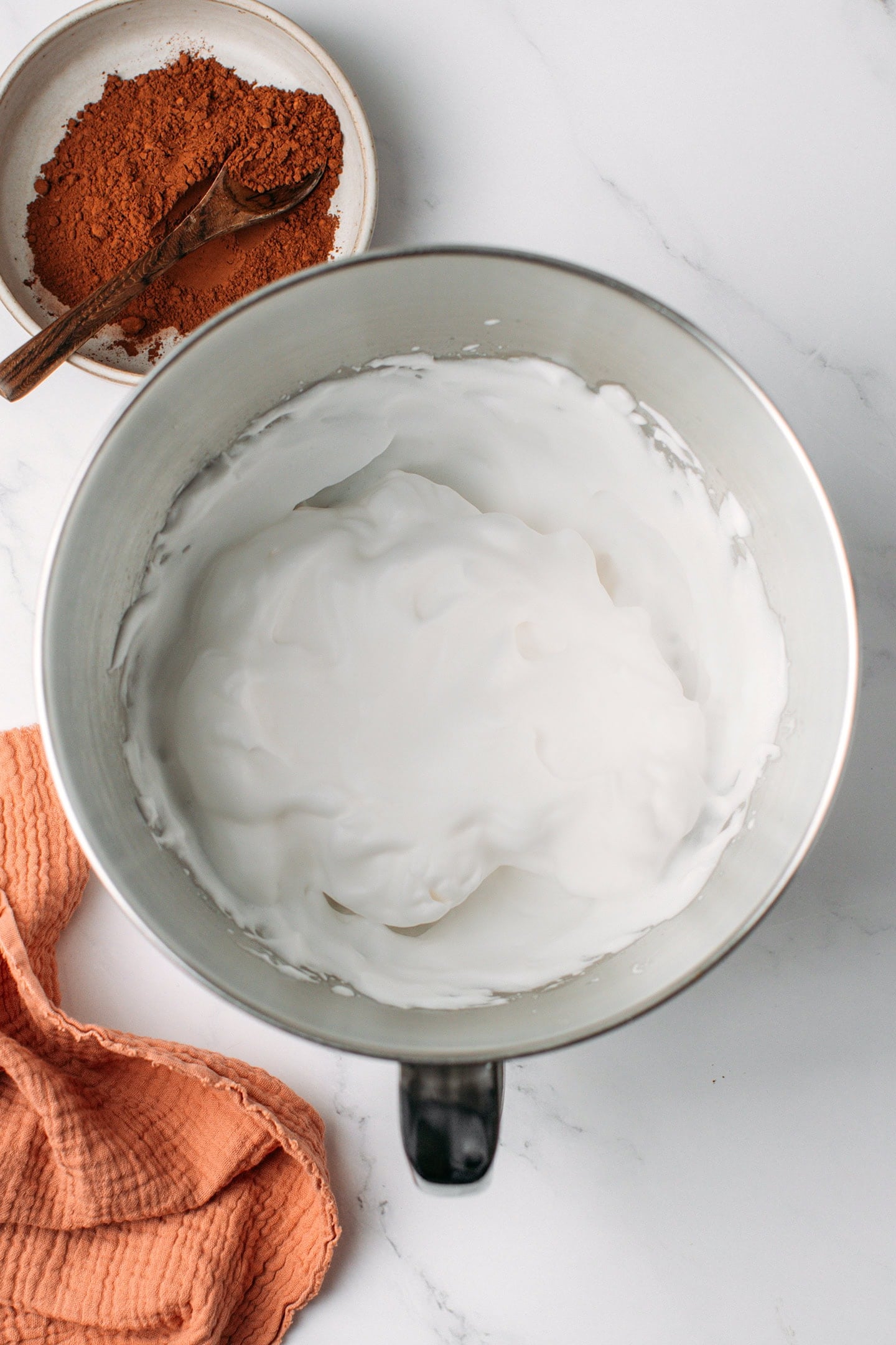 Whipped aquafaba in the bowl of a stand mixer.