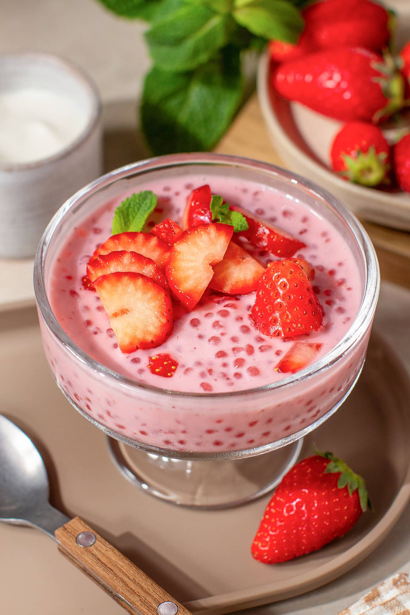 Strawberry sago topped with sliced strawberries in a serving ramekin.
