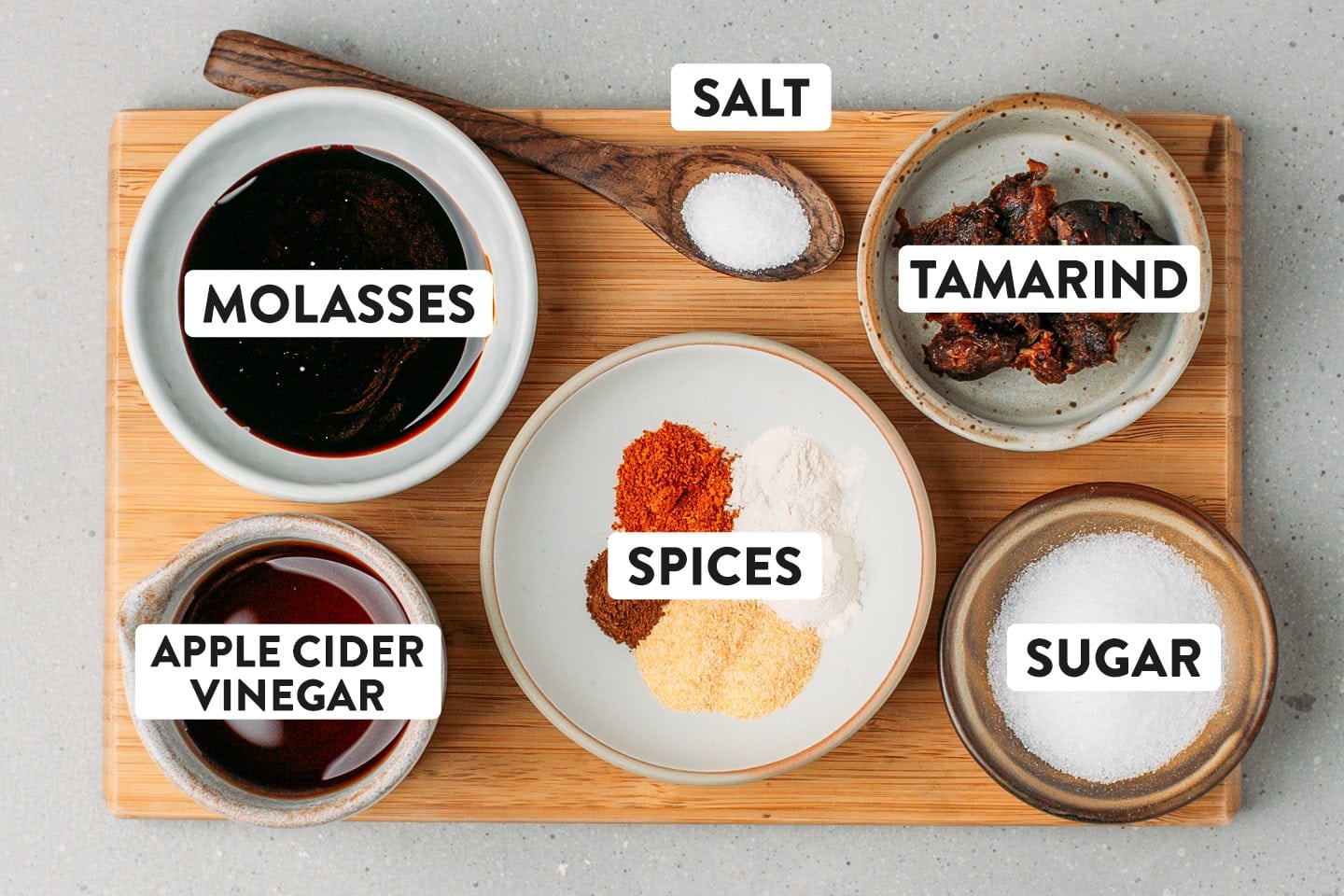 Ingredients like molasses, tamarind paste, apple cider vinegar, and spices.