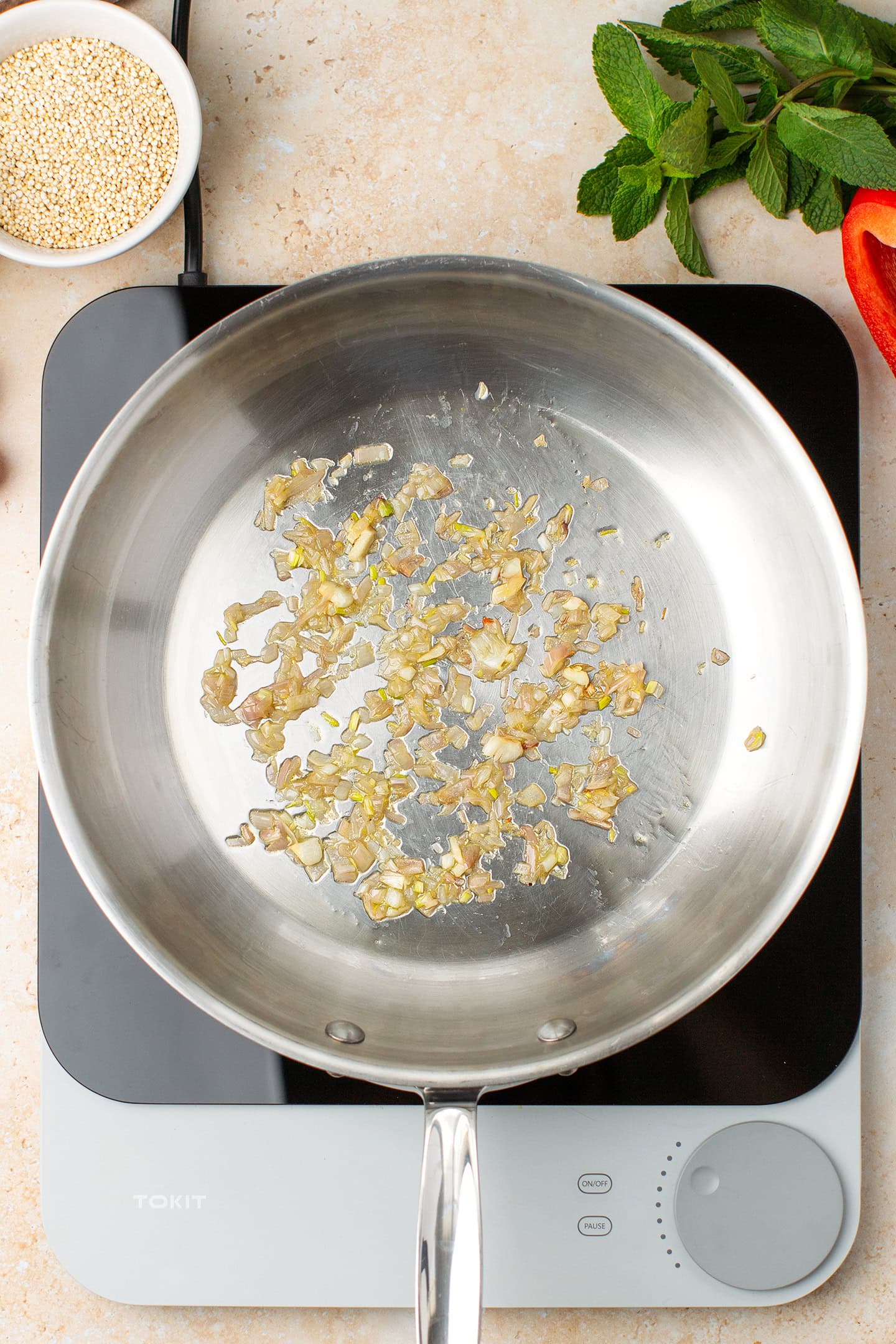 Sautéed minced shallot in a skillet.