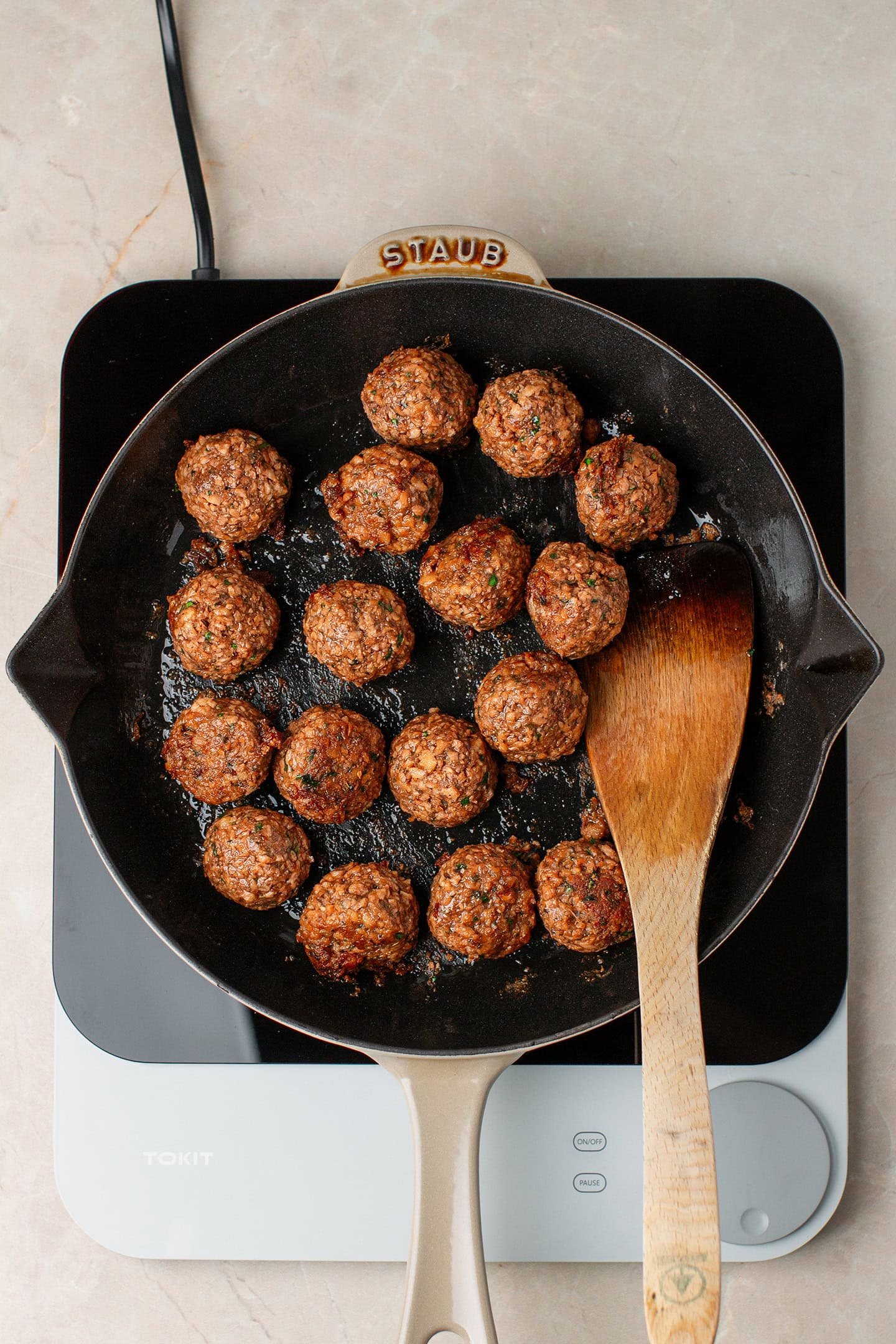 Sautéed vegan meatballs in a skillet.