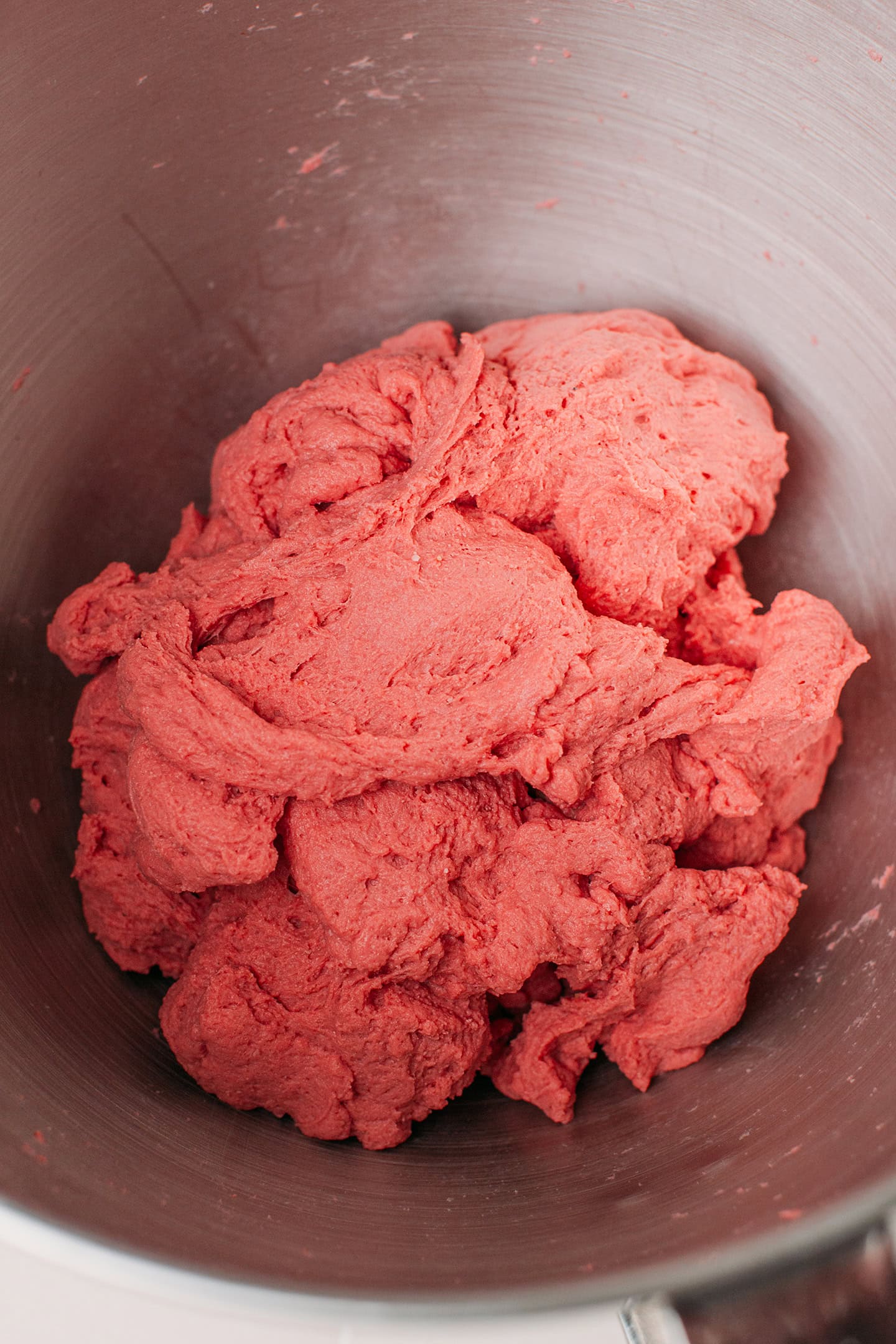 Red seitan dough in a stand mixer.
