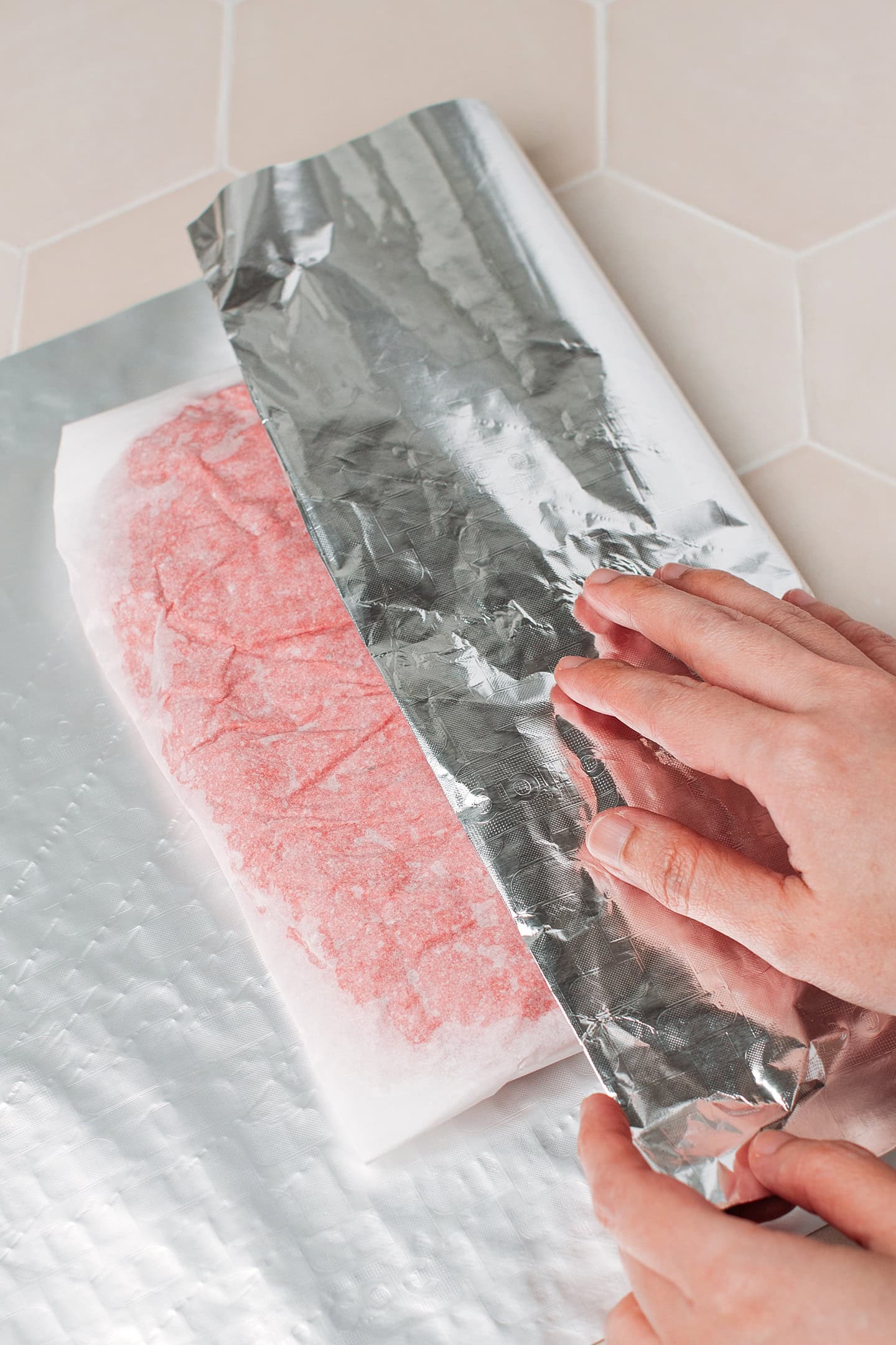 Wrapping seitan dough in aluminum foil.