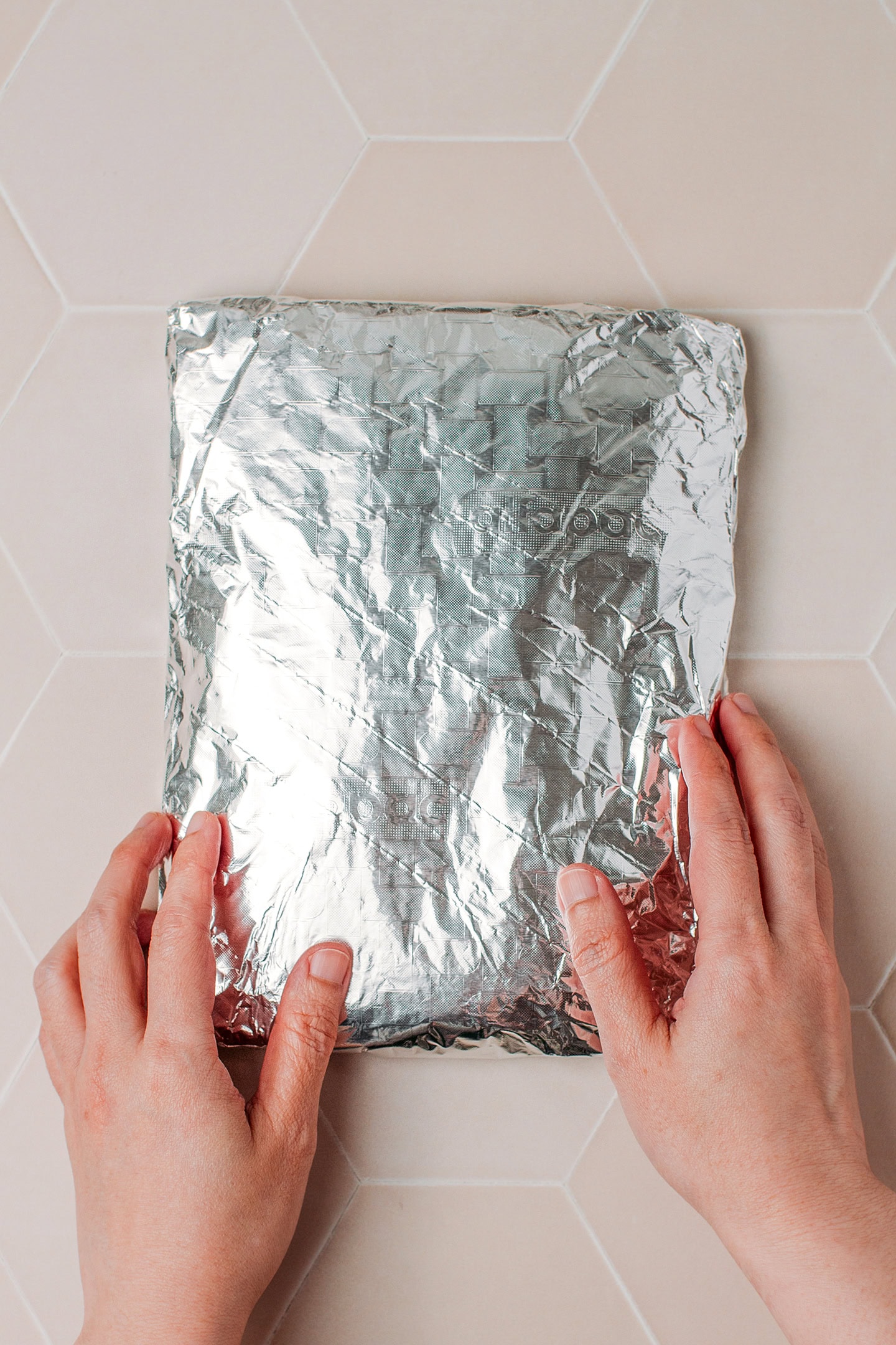 Wrapping seitan dough in aluminum foil a second time.