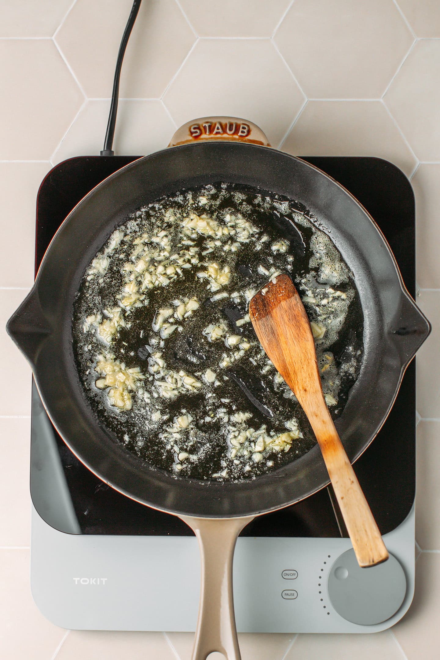 Sautéed garlic in melted butter in a skillet.