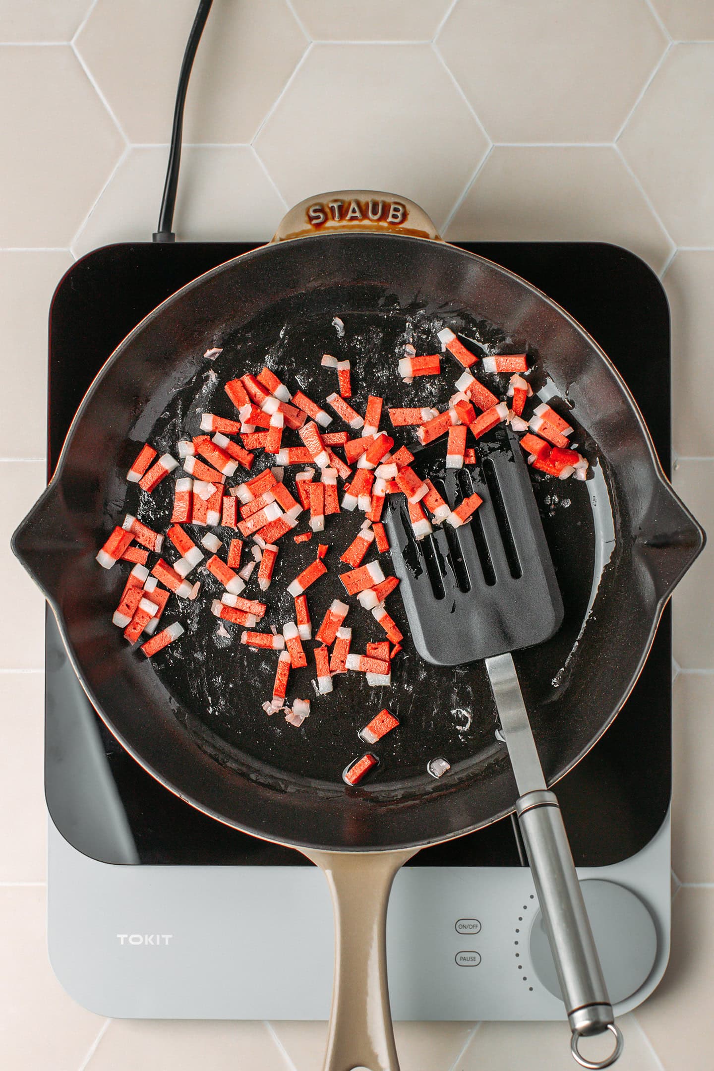 Sautéed vegan bacon bits in a skillet.