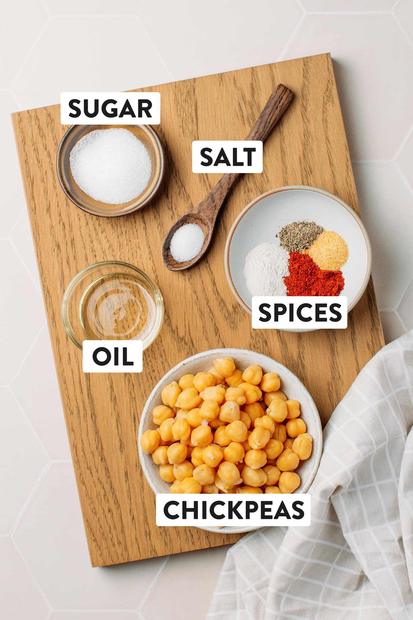 Ingredients like cooked chickpeas, oil, salt, and spices.