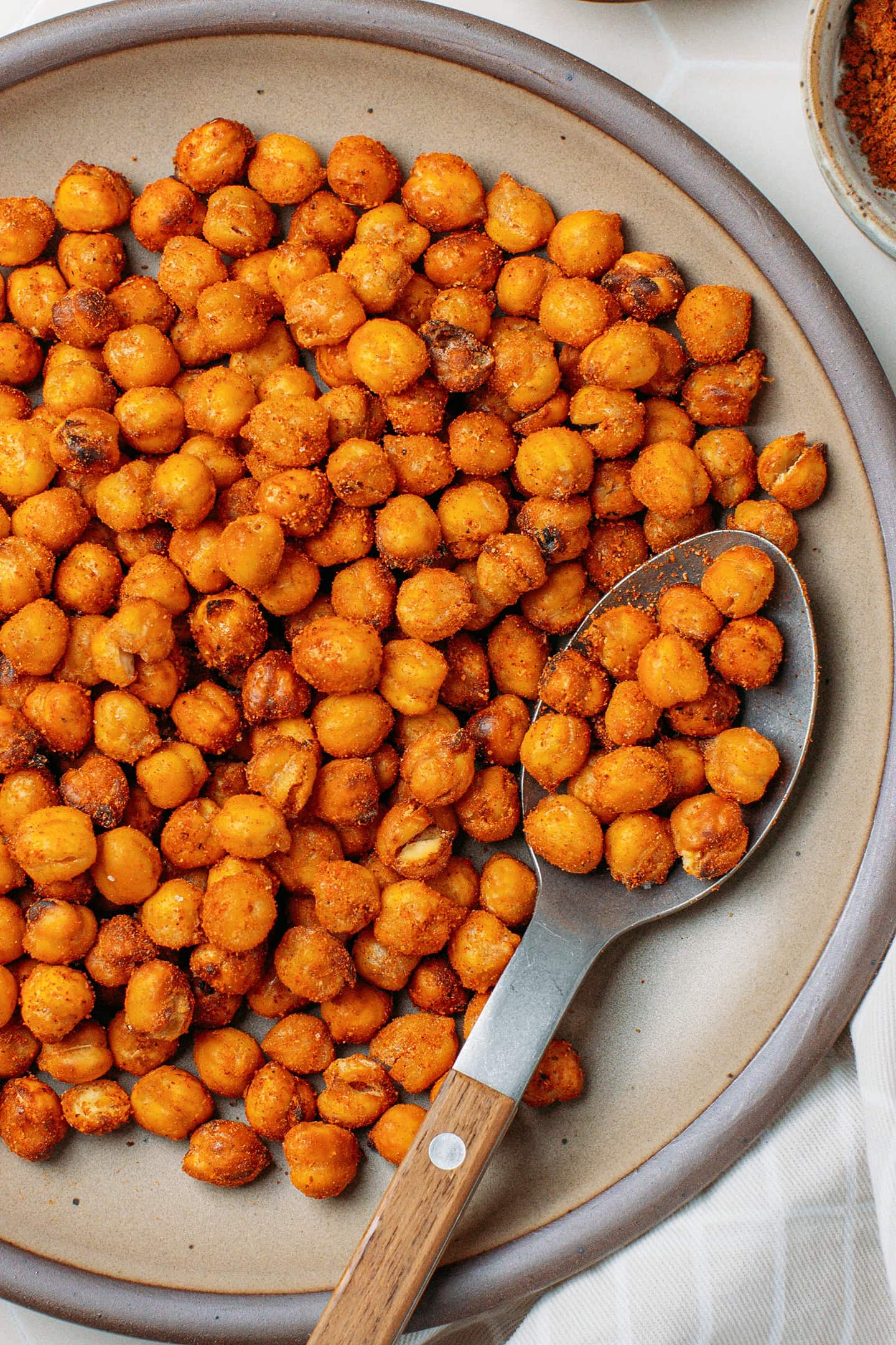 Brown plate filled with crispy chickpeas.